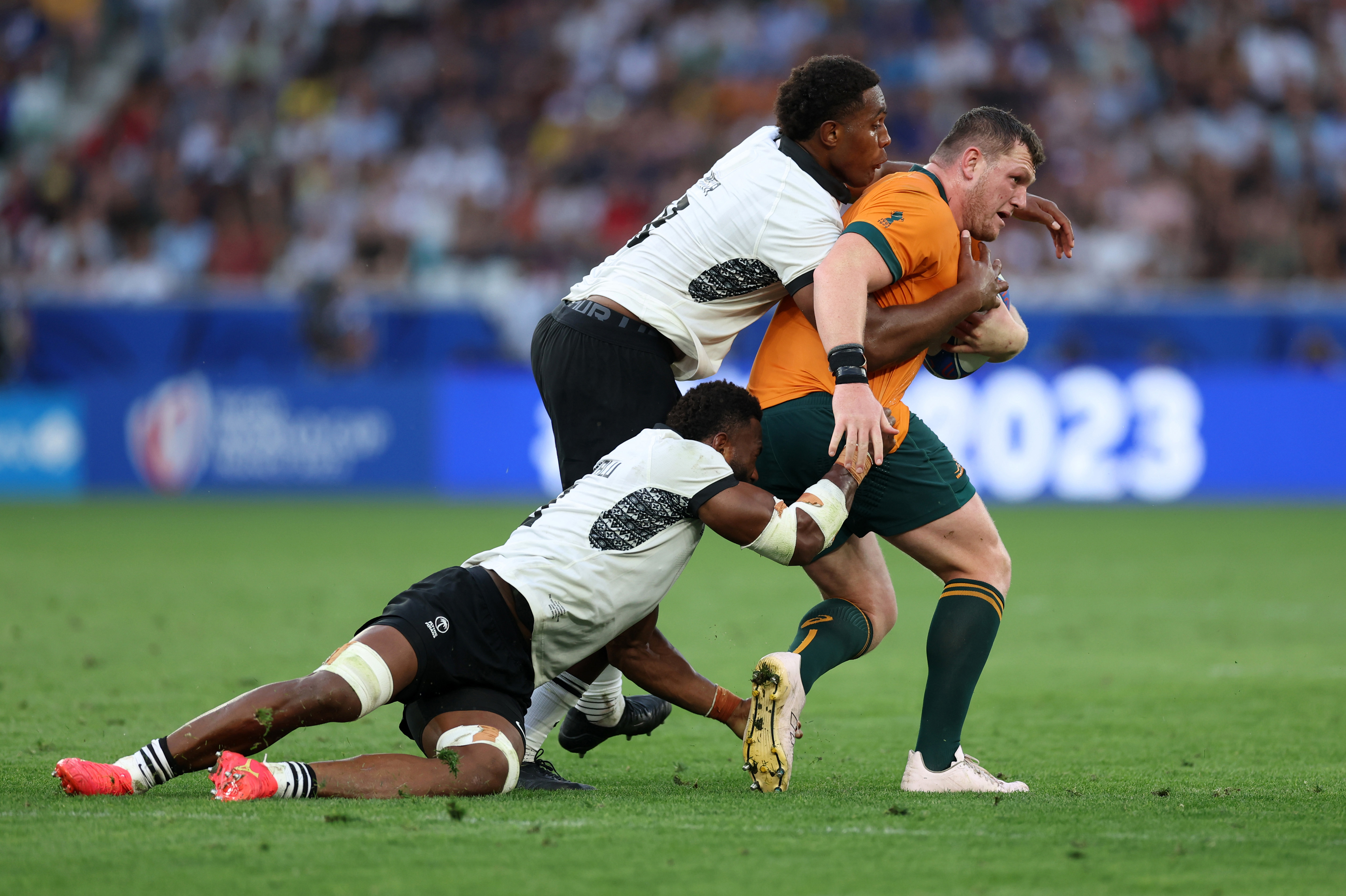 Lekima Tagitagivalu and Viliame Mata of Fiji tackle Angus Bell of Australia.