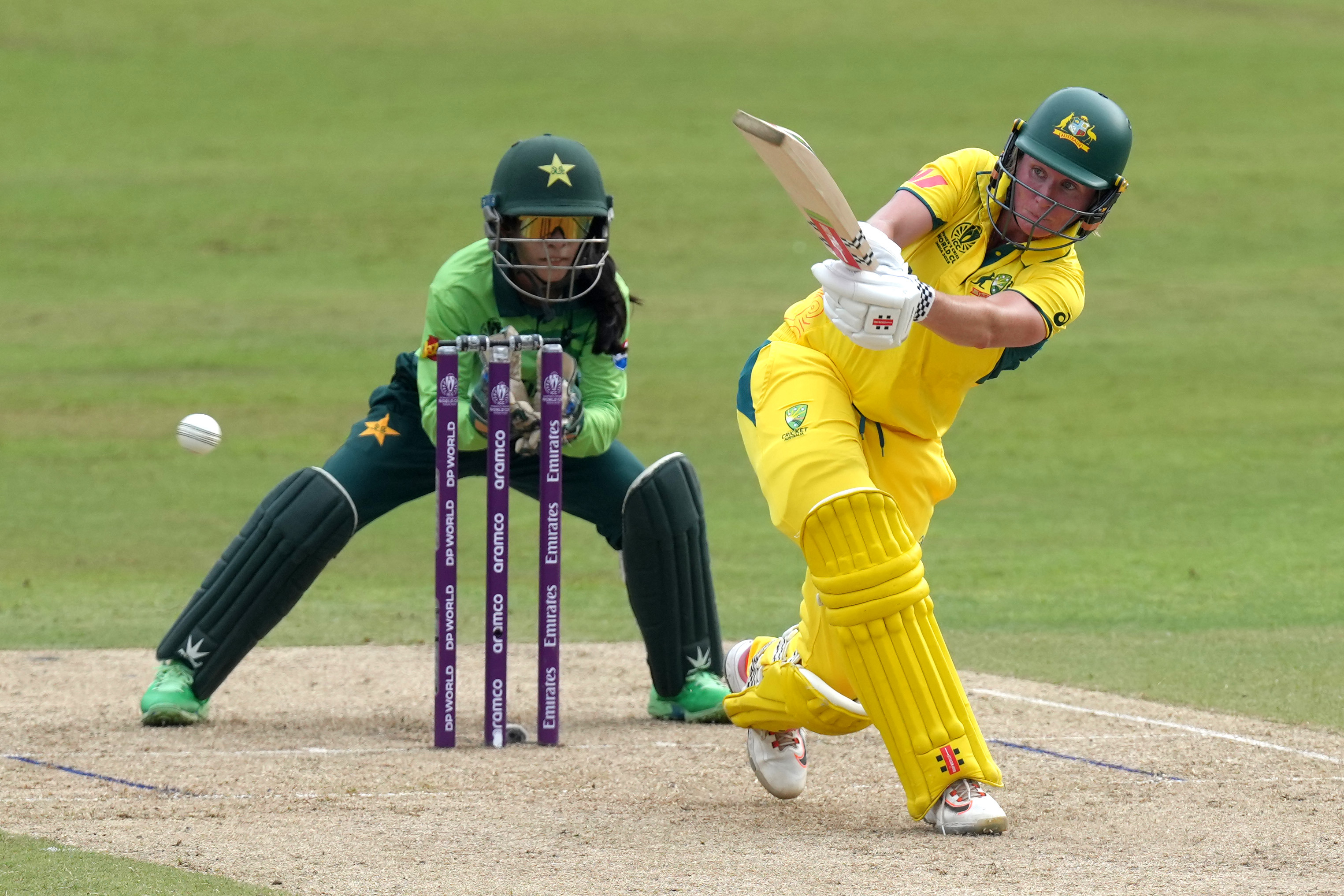 Australia's Beth Mooney plays a shot as Pakistan wicketkeeper Sidra Nawaz waits behind the stumps at the Women's Cricket World Cup.
