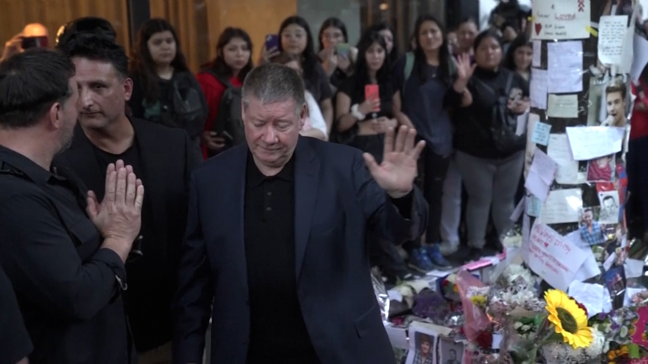 Liam Payne's father Geoff Payne greets mourning fans at memorial outside of Buenos Aires' Casa Sur hotel