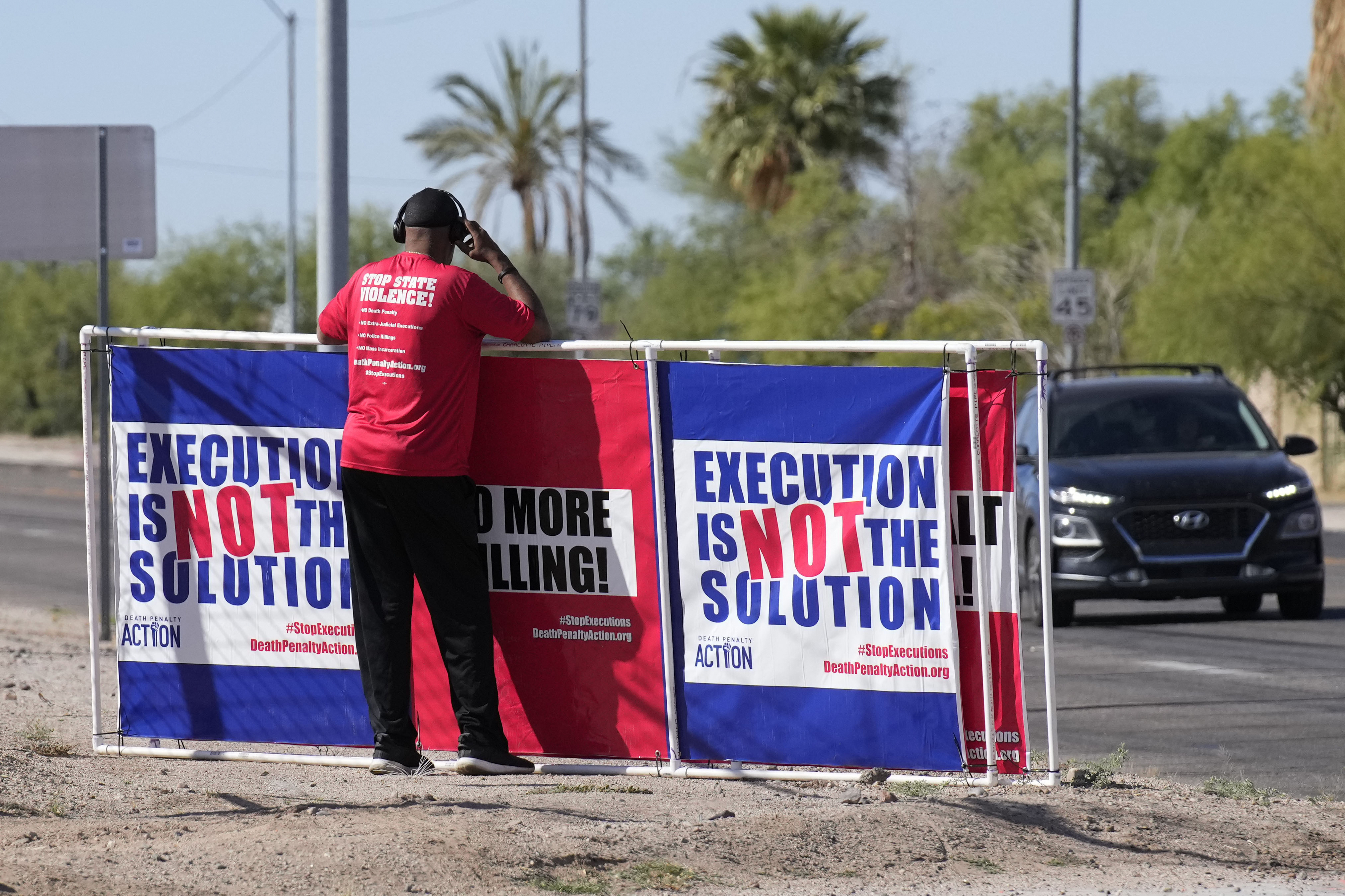 FILE - Charles Keith stands outside the state prison, Wednesday, May 11, 2022, in Florence, Ariz., where inmate Clarence Dixon was scheduled for execution by lethal injection for his murder conviction in the killing of 21-year-old Arizona State University student Deana Bowdoin in 1978. Public support and use of the death penalty in 2022 continued its more than two-decade long decline in the U.S., and many of the executions that were carried out were botched or highly problematic, according to an