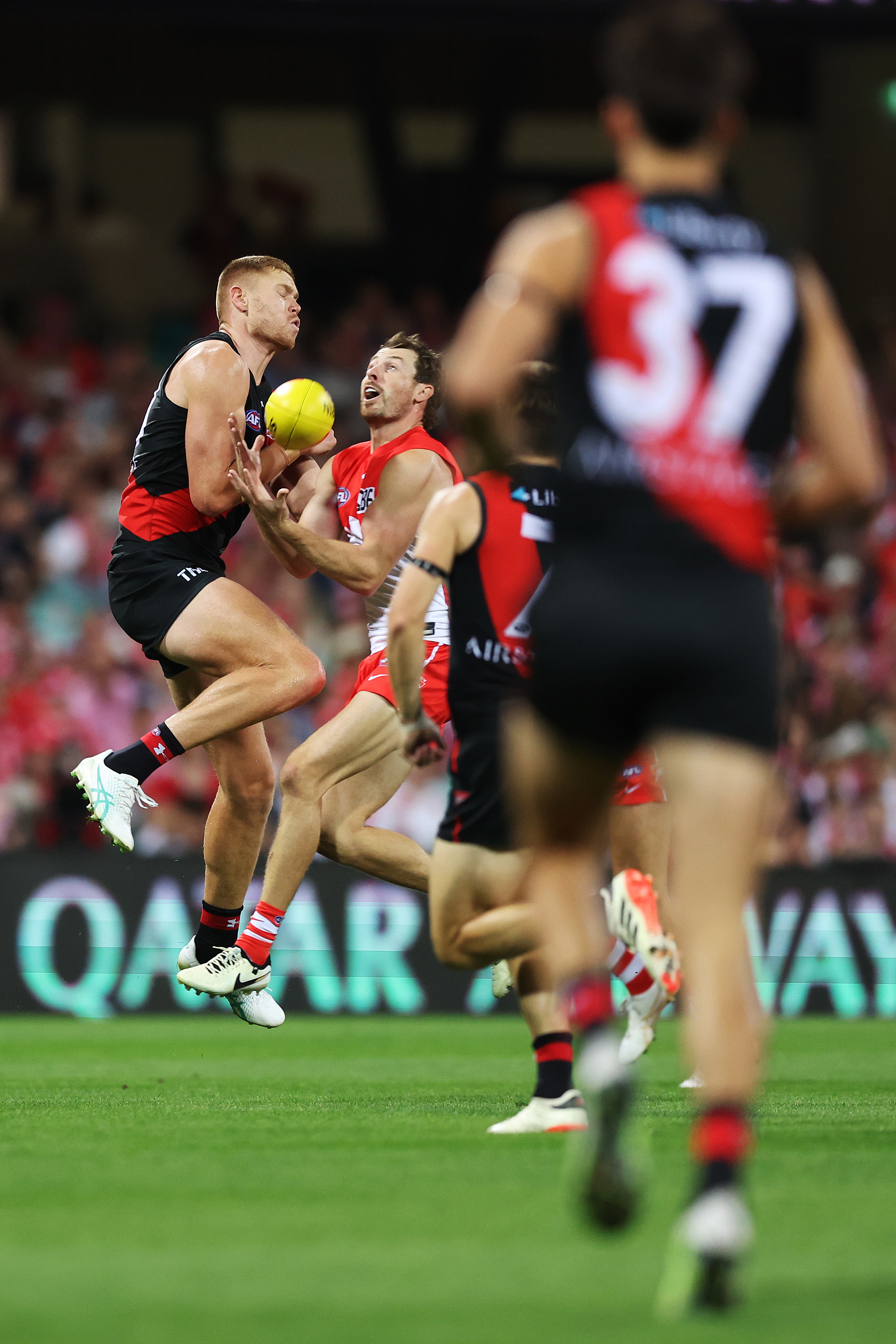 Harry Cunningham of the Swans is challenged by Peter Wright of the Bombers in a marking contest.