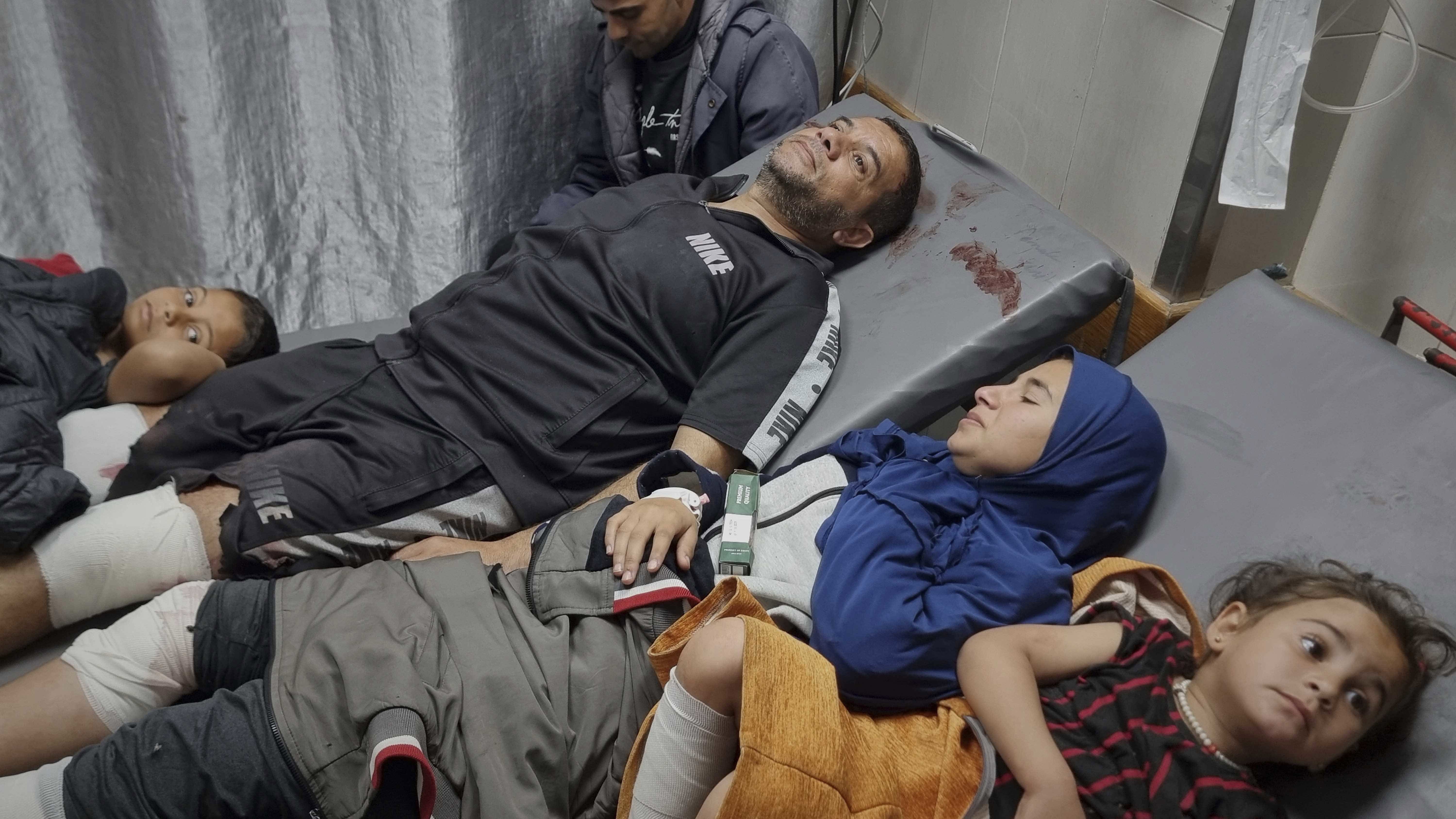 Injured Palestinians wait for treatment at the hospital following Israeli army airstrikes in Khan Younis, southern Gaza Strip, Tuesday, March 18, 2025. 