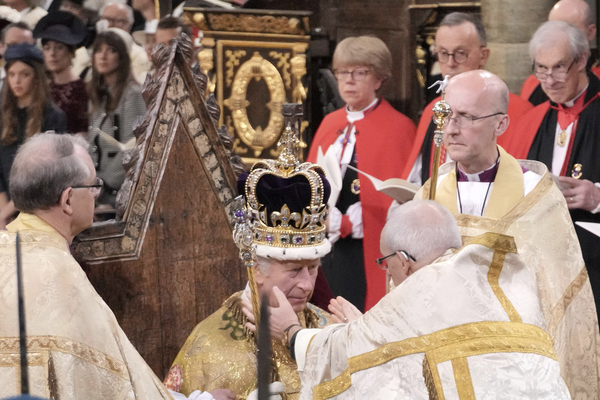 King Charles III sits as he is crowned with St Edward's Crown by The Archbishop of Canterbury the Most Reverend Justin Welby during the coronation ceremony at Westminster Abbey, London, Saturday, May 6, 2023. (Jonathan Brady/Pool Photo via AP)