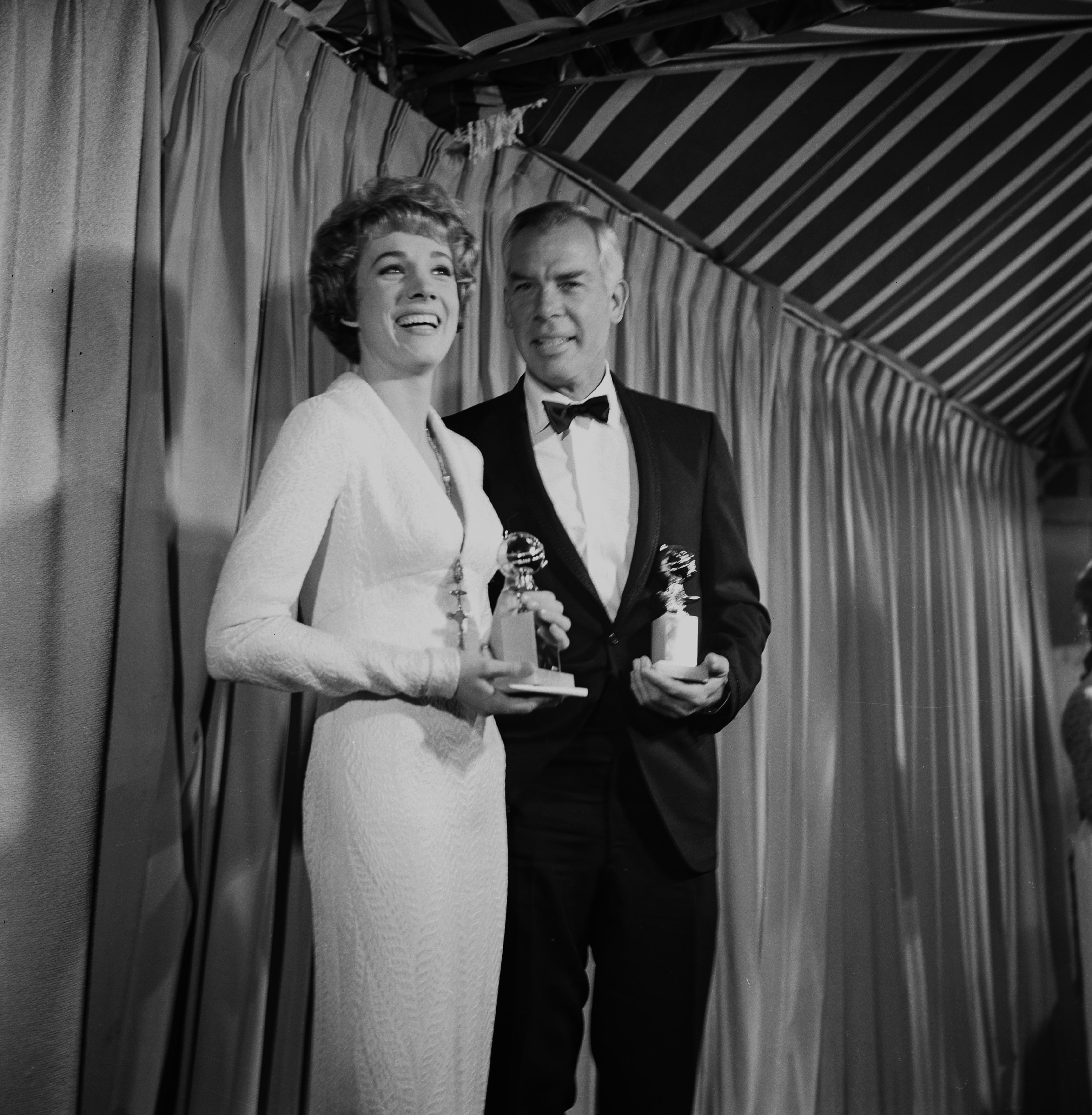 Julie Andrews and Lee Marvin pose with their Golden Globe Awards for Best Actress and Actor in Los Angeles, California in 1964. 
