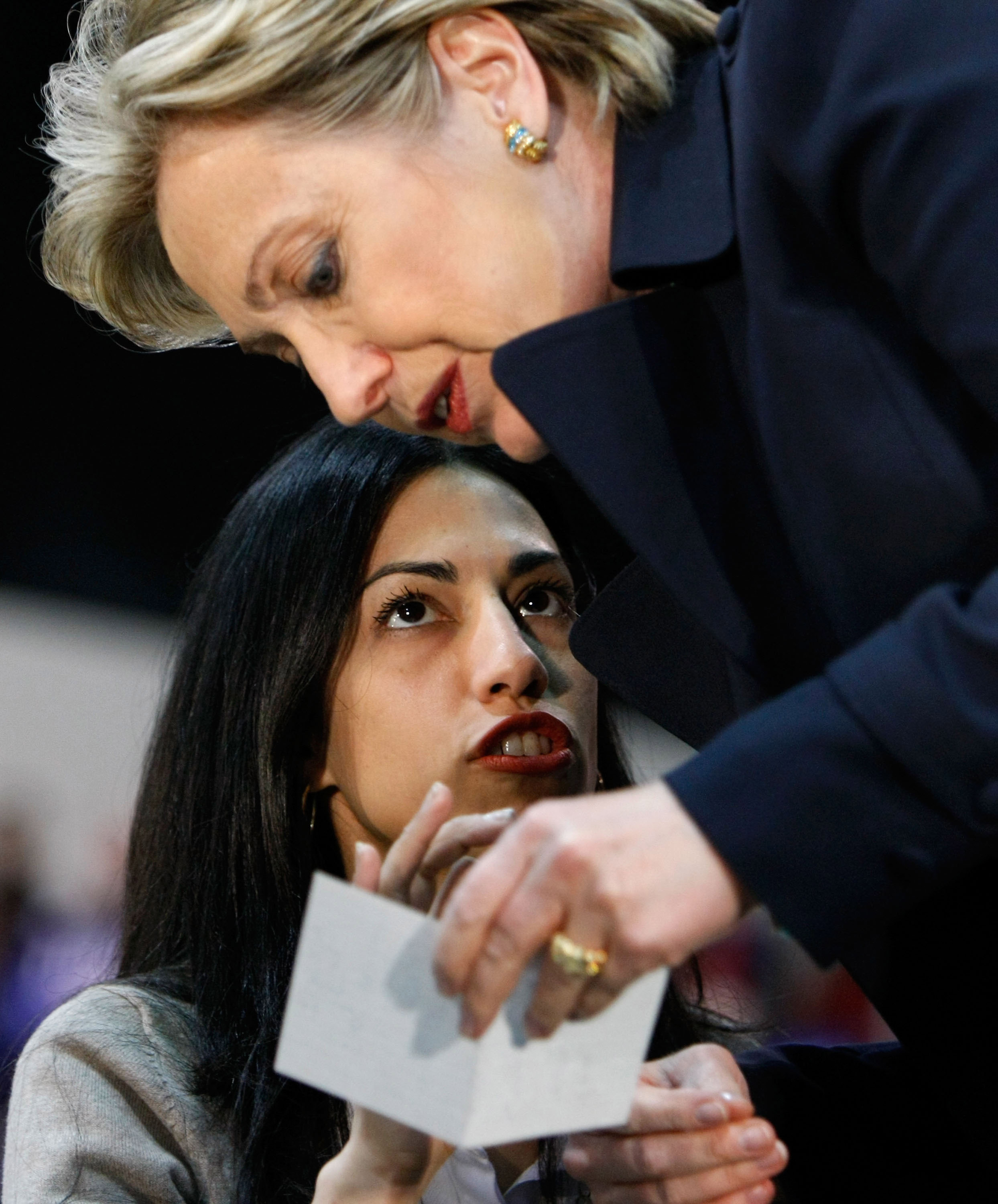 Presidential hopeful Hillary Clinton talks with top aide Huma Abedin before a rally at California State Los Angeles February 2, 2008