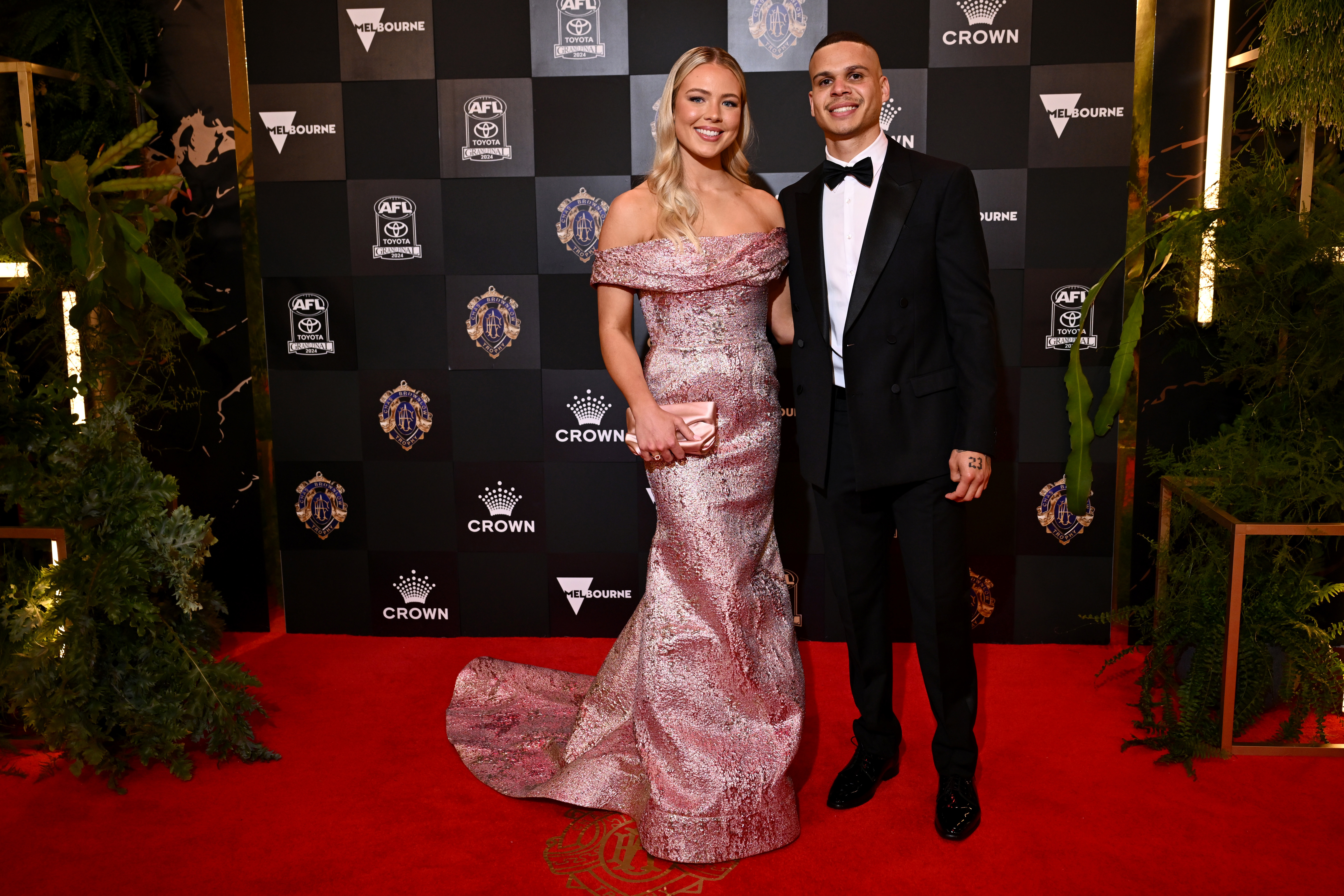 Bobby Hill of the Collingwood Magpies and partner Georgia Devlin arrive ahead of the 2024 Brownlow Medal at Crown Palladium on September 23, 2024 in Melbourne, Australia.