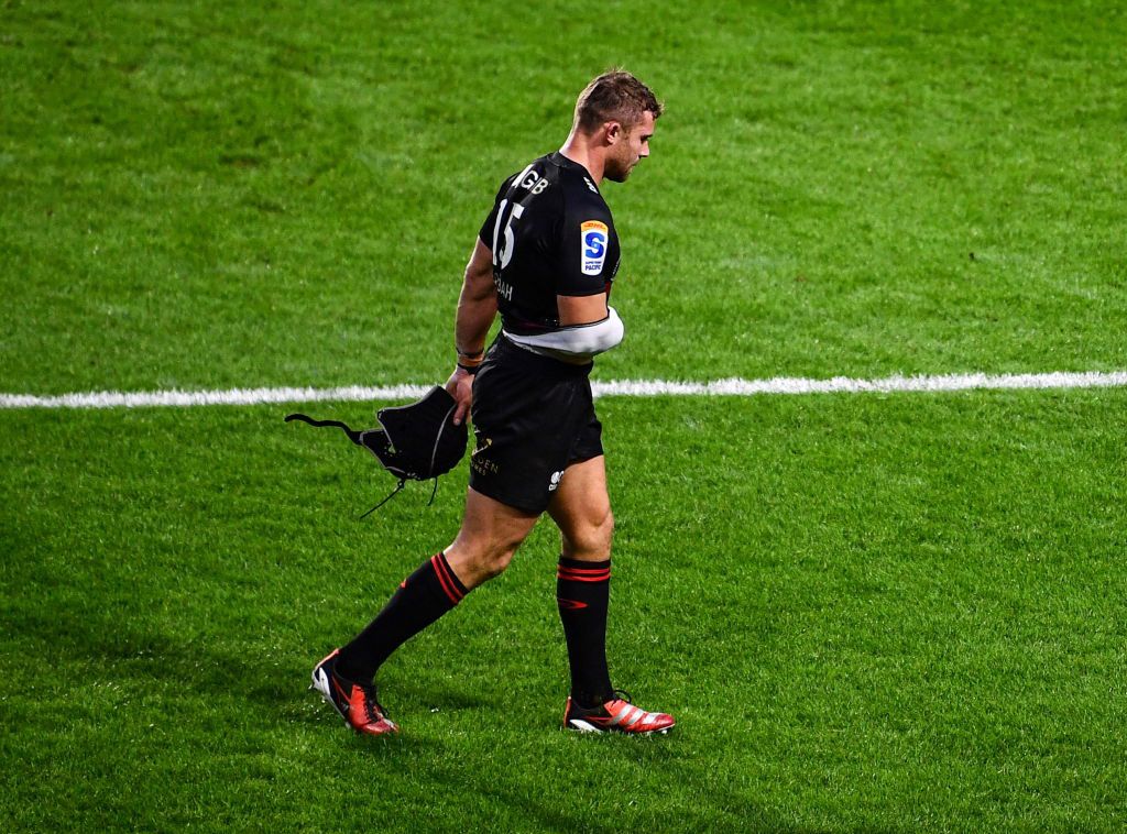 Leigh Halfpenny of the Crusaders leaves the field after picking up an injury.
