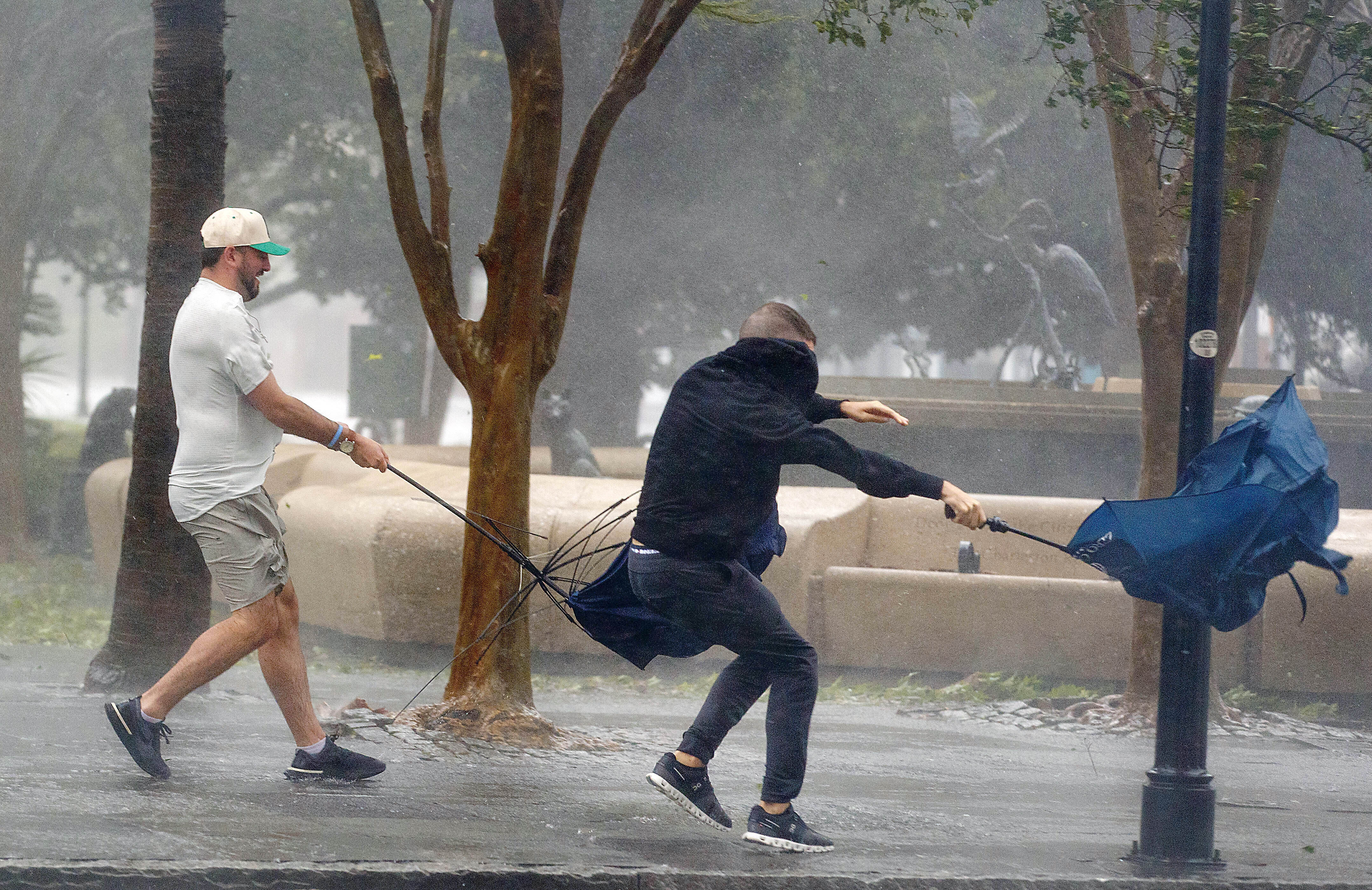 Wind gusts, blowing down King Street, twist umbrellas during Hurricane Ian in Charleston, South Carolina, on Friday, September 30, 2022 