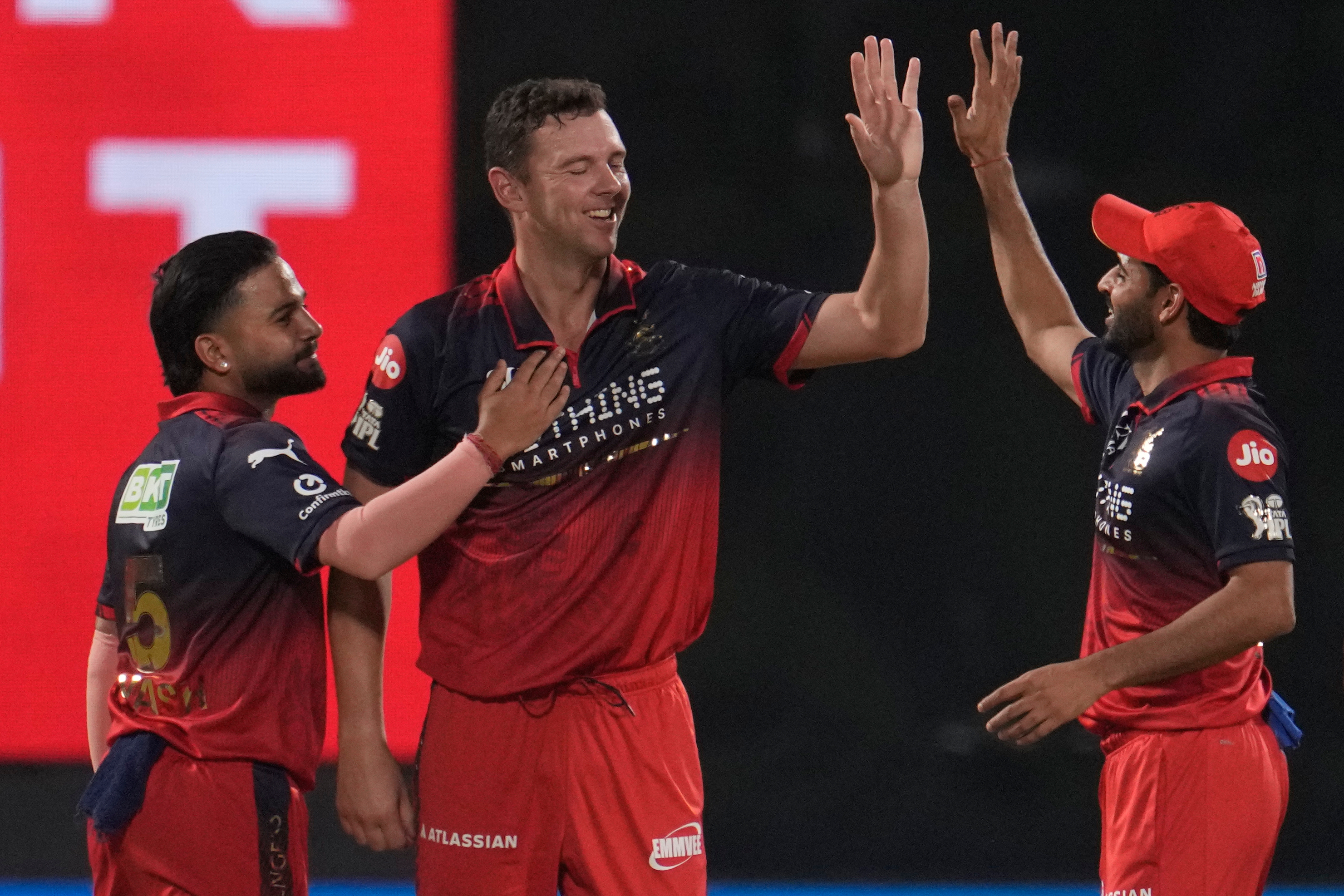 Royal Challengers Bengaluru's Josh Hazlewood celebrates the wicket of Delhi Capitals' Sameer Rizvi.