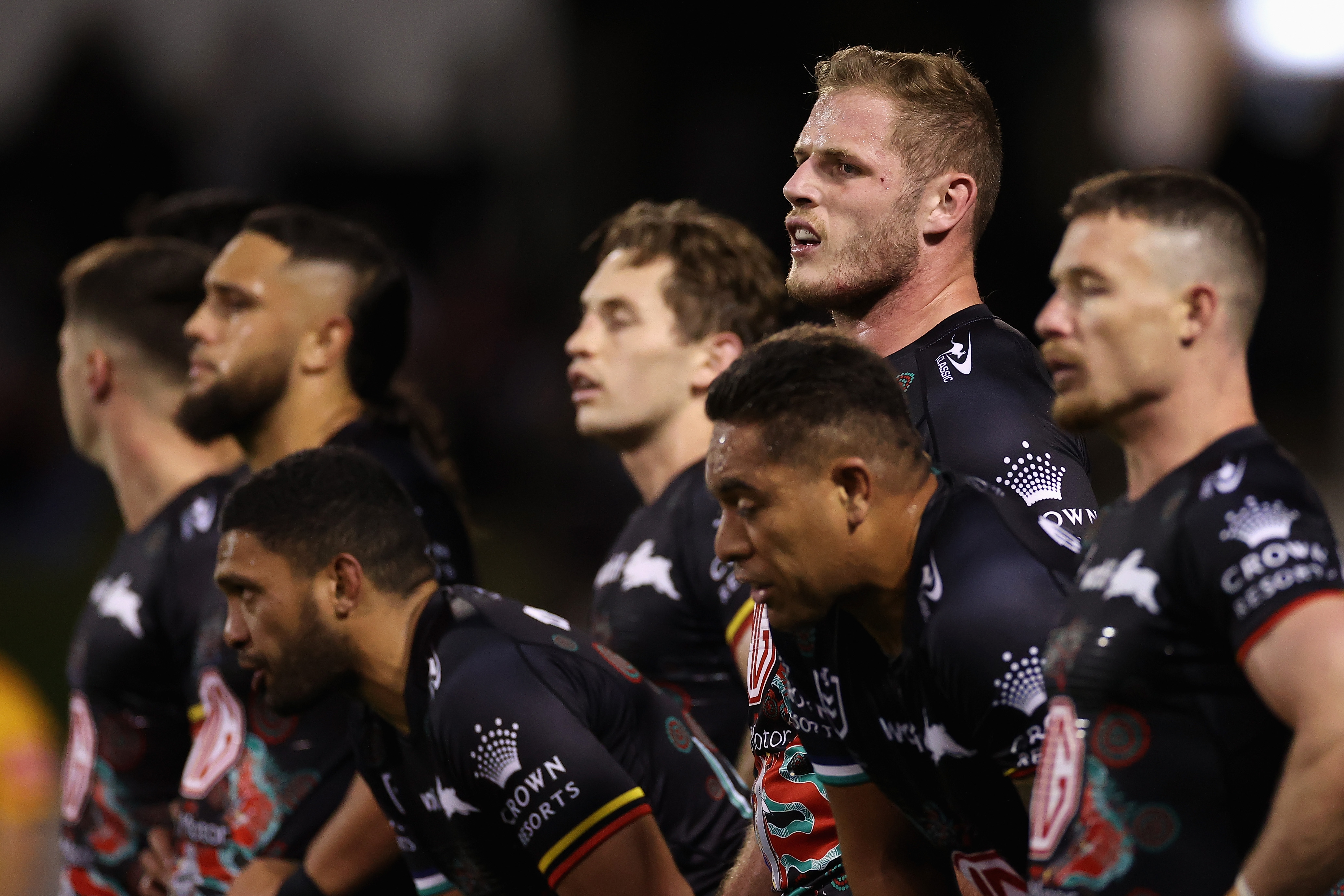 Thomas Burgess of the Rabbitohs and teammates look on after a Dragons try.