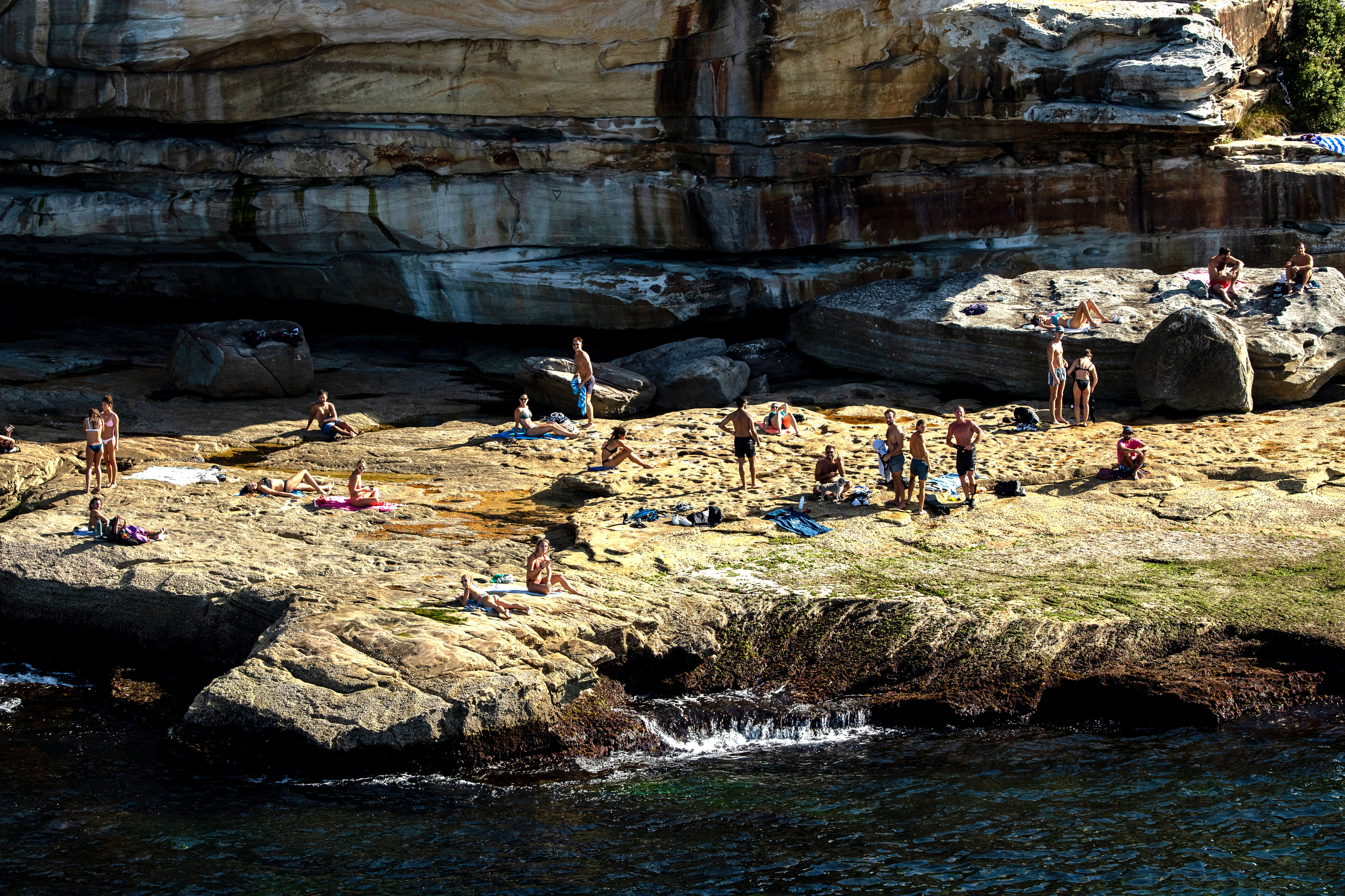 People are seen on rocks at the south end of Bondi Beach in Sydney, Australia.