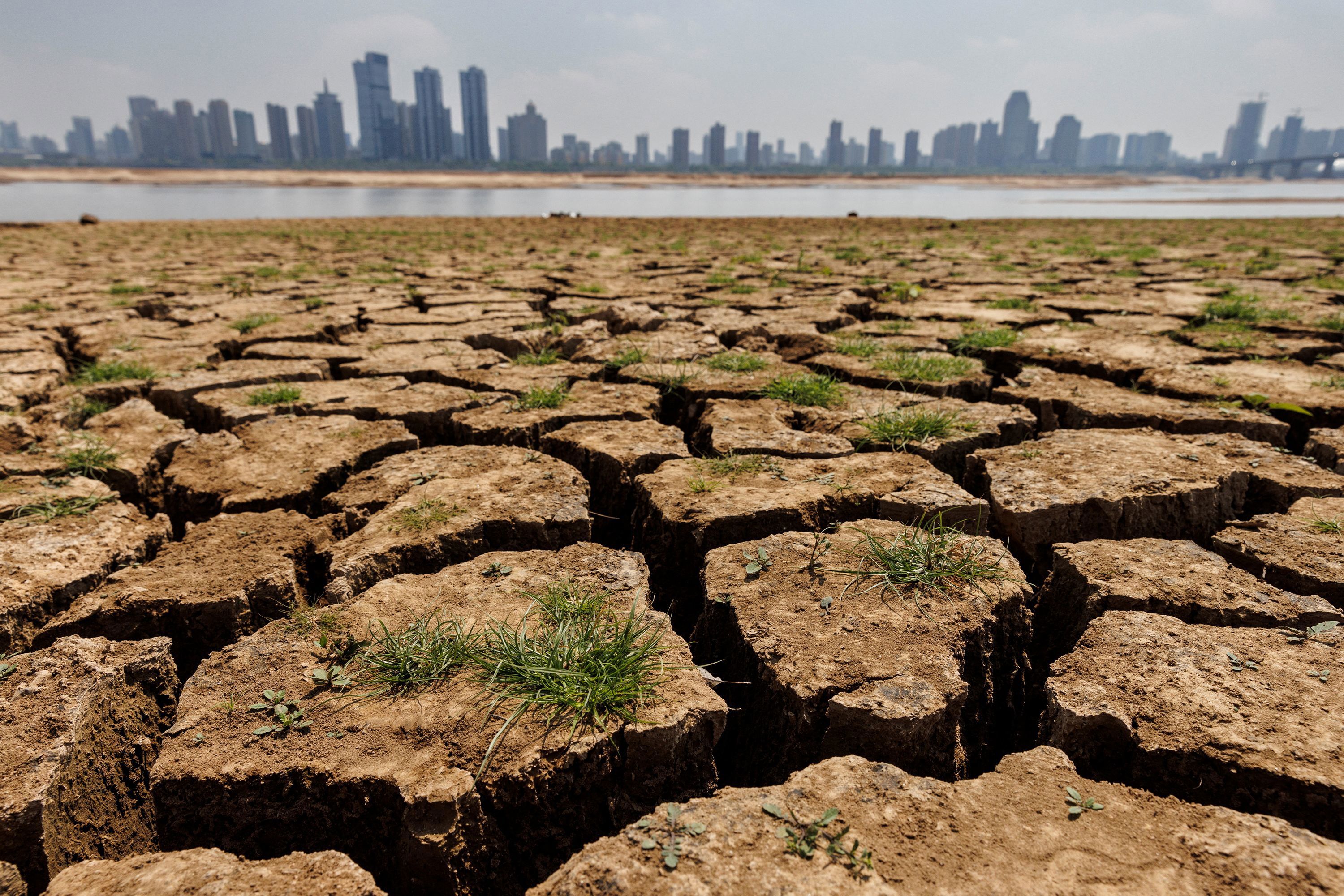 Cracks run through the partially dried-up river bed of the Gan River, during a drought in Nanchang, Jiangxi province, China, August 28, 2022.