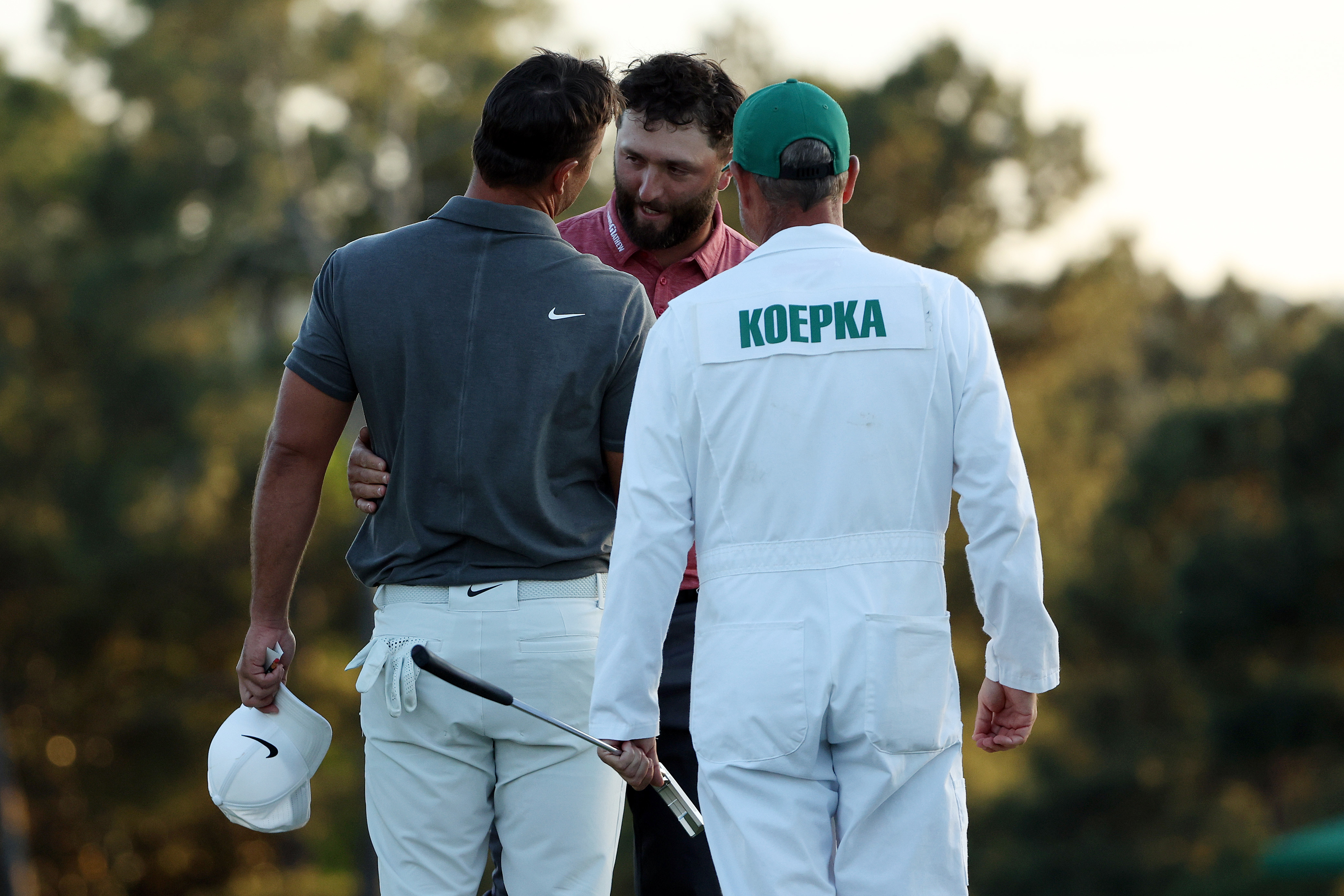 AUGUSTA, GEORGIA - APRIL 09: Jon Rahm of Spain shakes hands with Brooks Koepka of the United States on the 18th green after he won the 2023 Masters Tournament at Augusta National Golf Club on April 09, 2023 in Augusta, Georgia. (Photo by Patrick Smith/Getty Images)