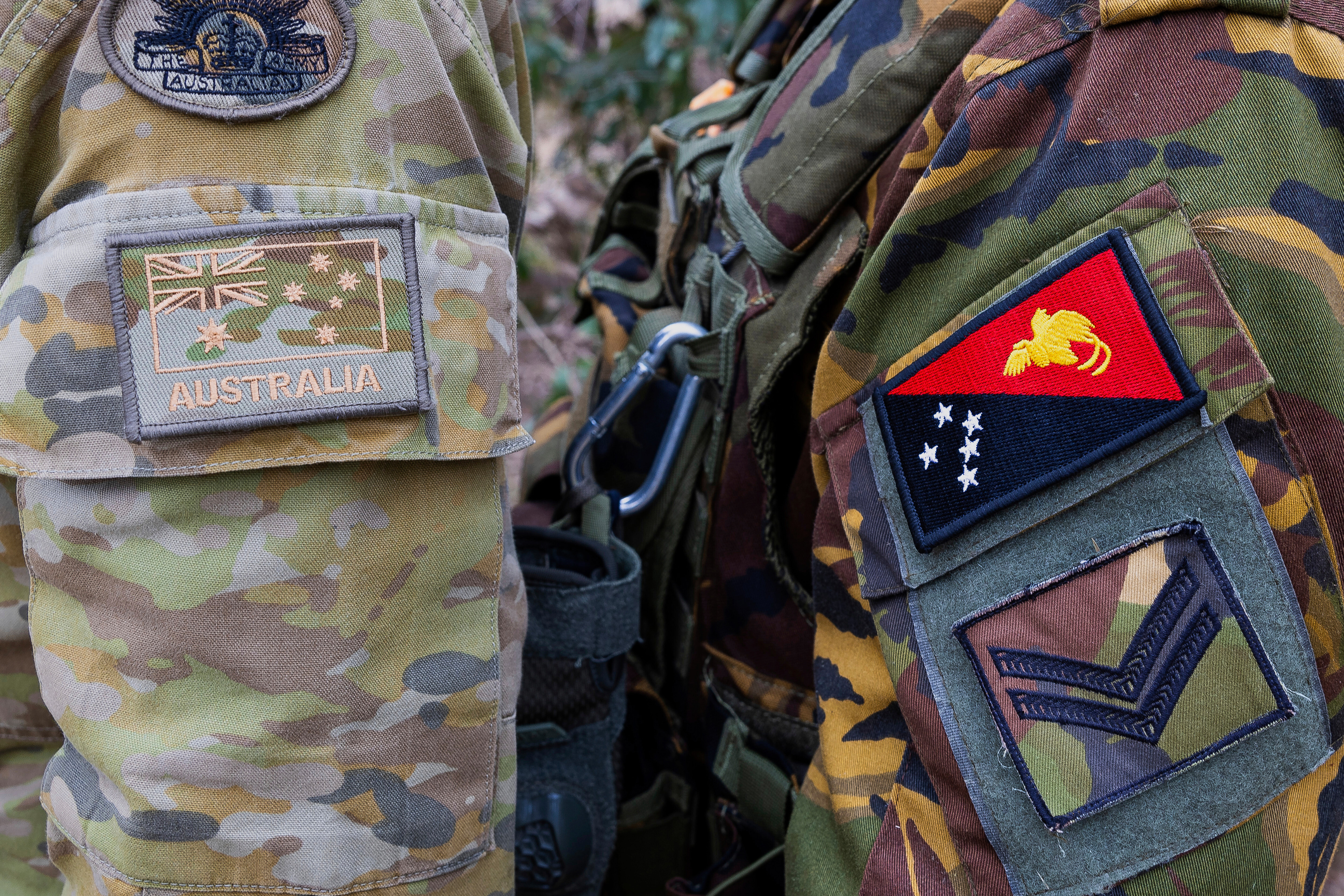 The emblem of an Australian Army soldier, left, and a Papua New Guinea Defence Force soldier during an exercise at Talisman Sabre in Townsville, Australia, on July 21, 2025.