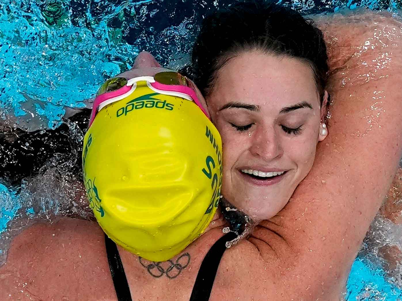 Kaylee McKeown, of Australia, is congratulated by teammate Emily Seebohm after winning the final of the women's 100m backstroke at the 2020 Summer Olympics.