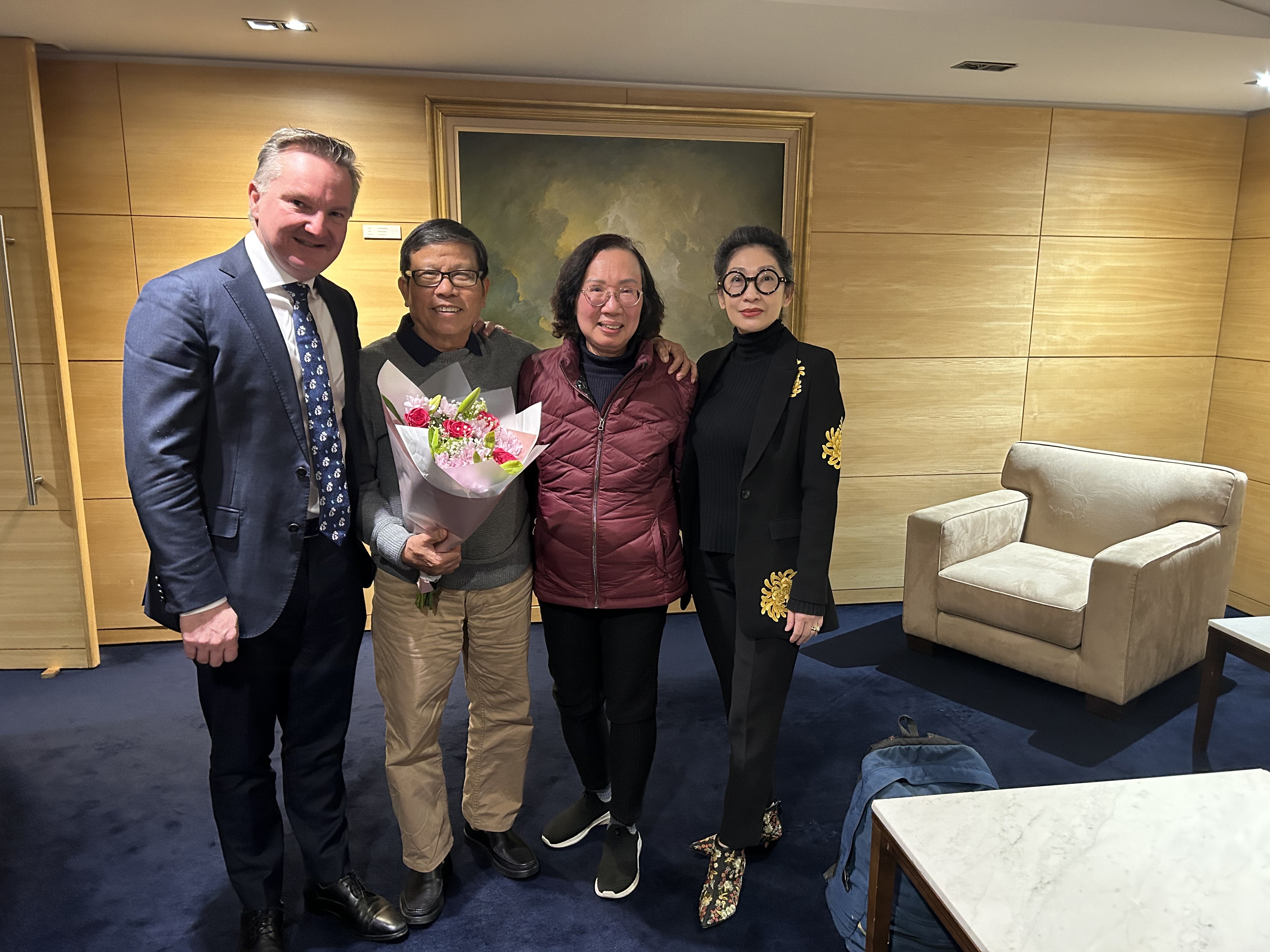 Chau Van Kham with his wife, Quynh Trang Truong, both centre, and Kham's lawyer (right) and MP Chis Bowen (left).