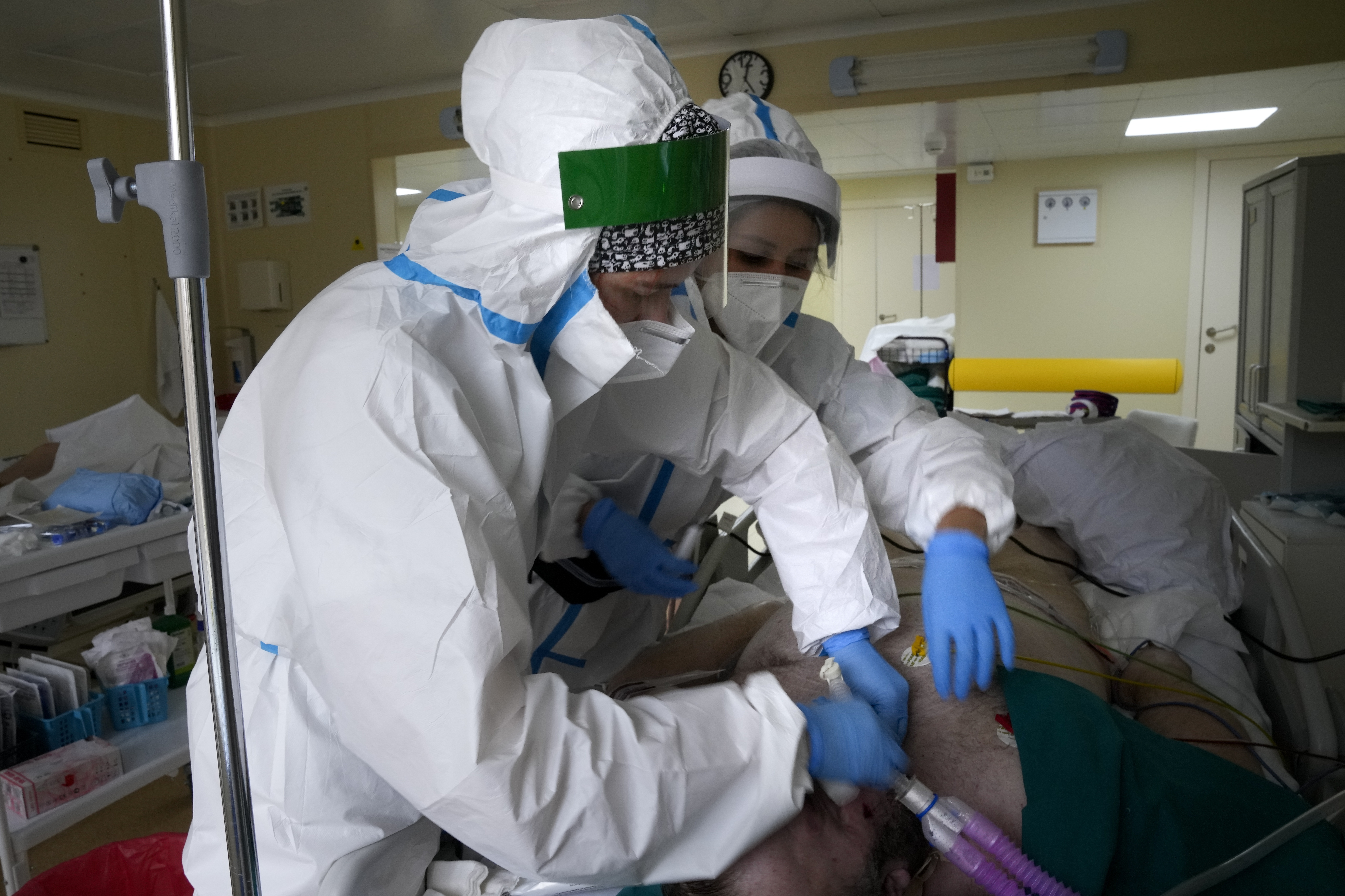 Medical staff members wearing a special suit to protect against COVID-19 treat a patient with coronavirus at an ICU at the Moscow City Clinical Hospital.