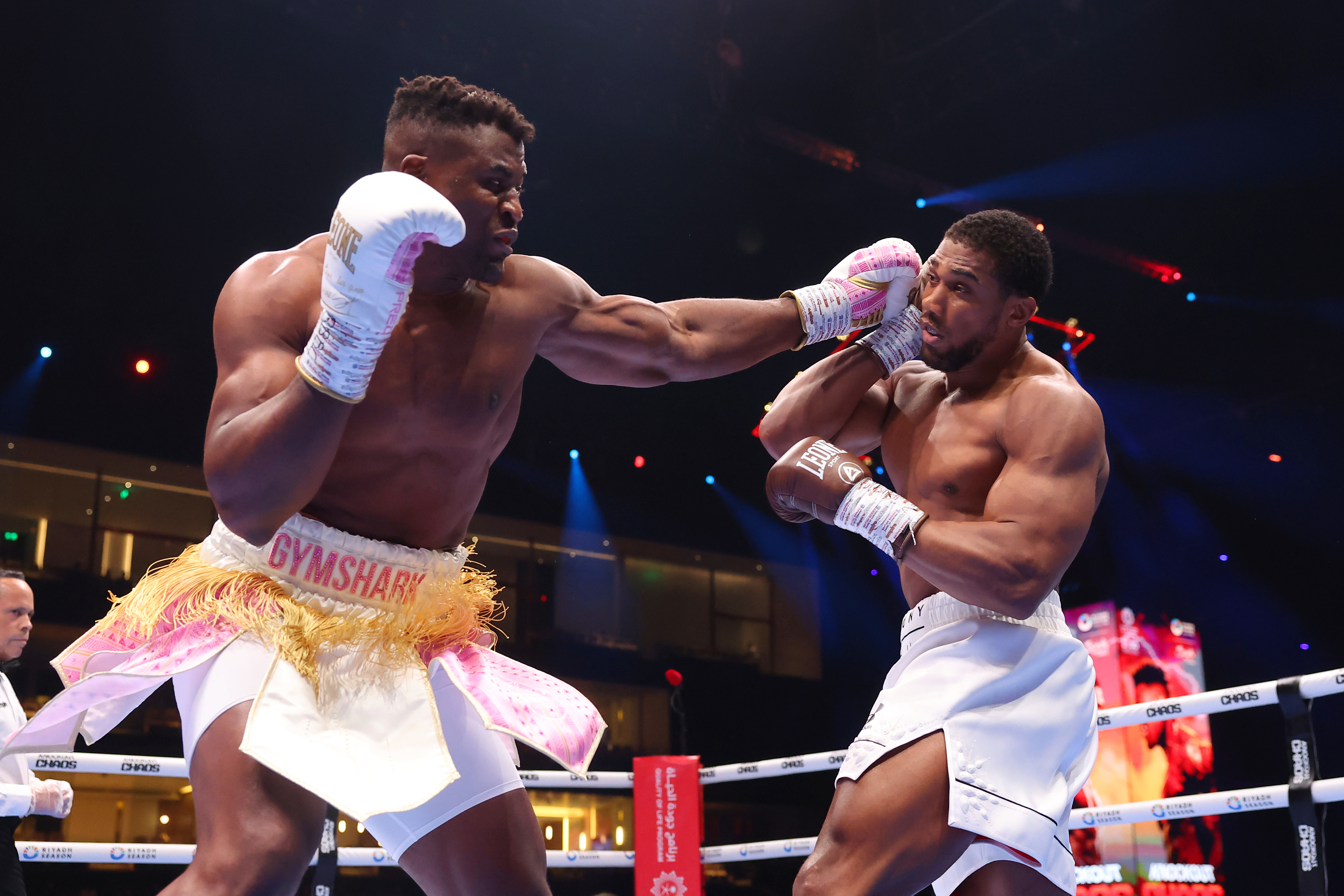 Francis Ngannou punches Anthony Joshua during the Heavyweight fight between Anthony Joshua and Francis Ngannou on the Knockout Chaos boxing card at the Kingdom Arena on March 08, 2024 in Riyadh, Saudi Arabia. (Photo by Richard Pelham/Getty Images)
