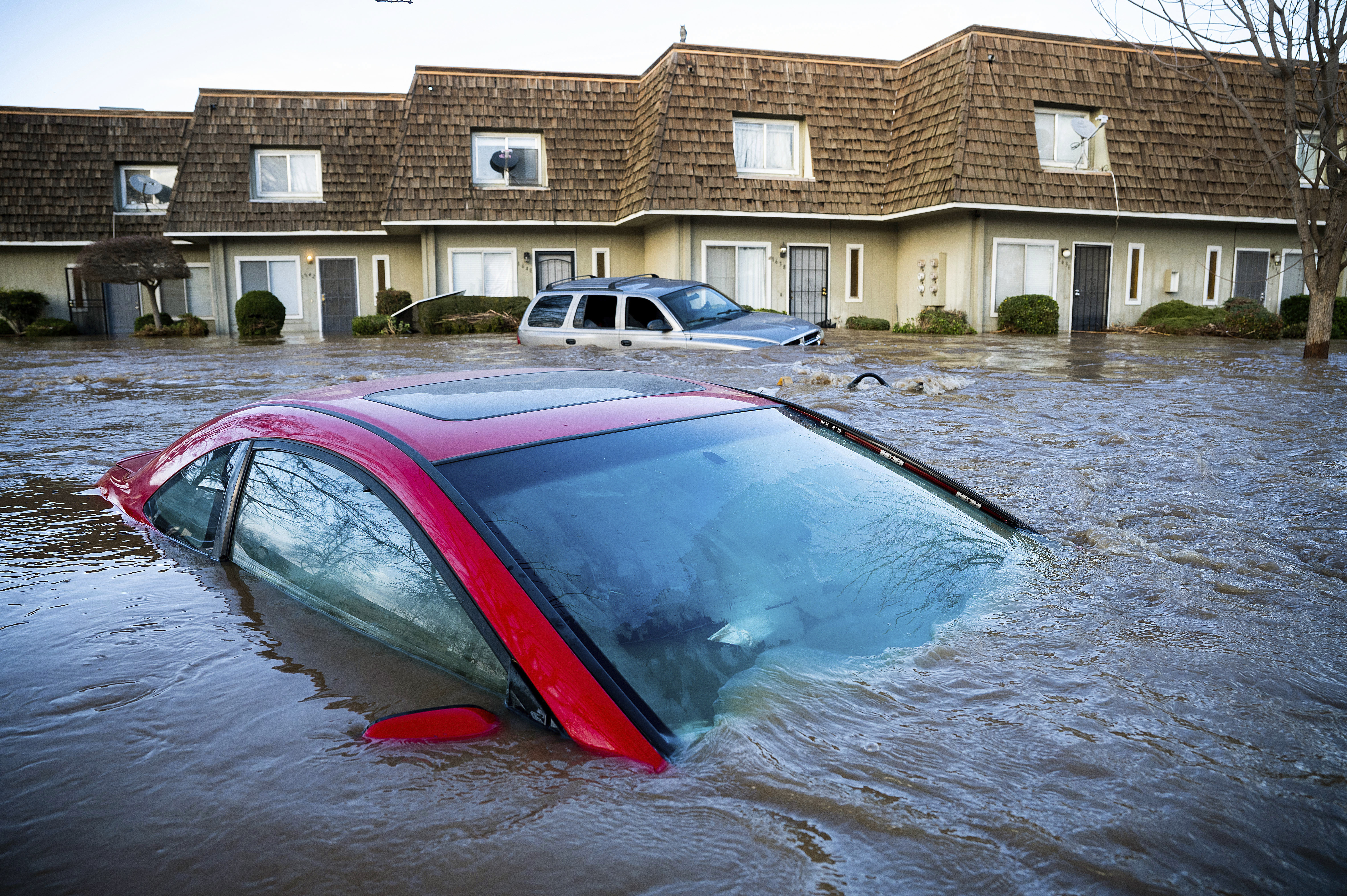 Floodwaters course through a neighborhood in Merced, Calif., on Tuesday, Jan. 10, 2023.  