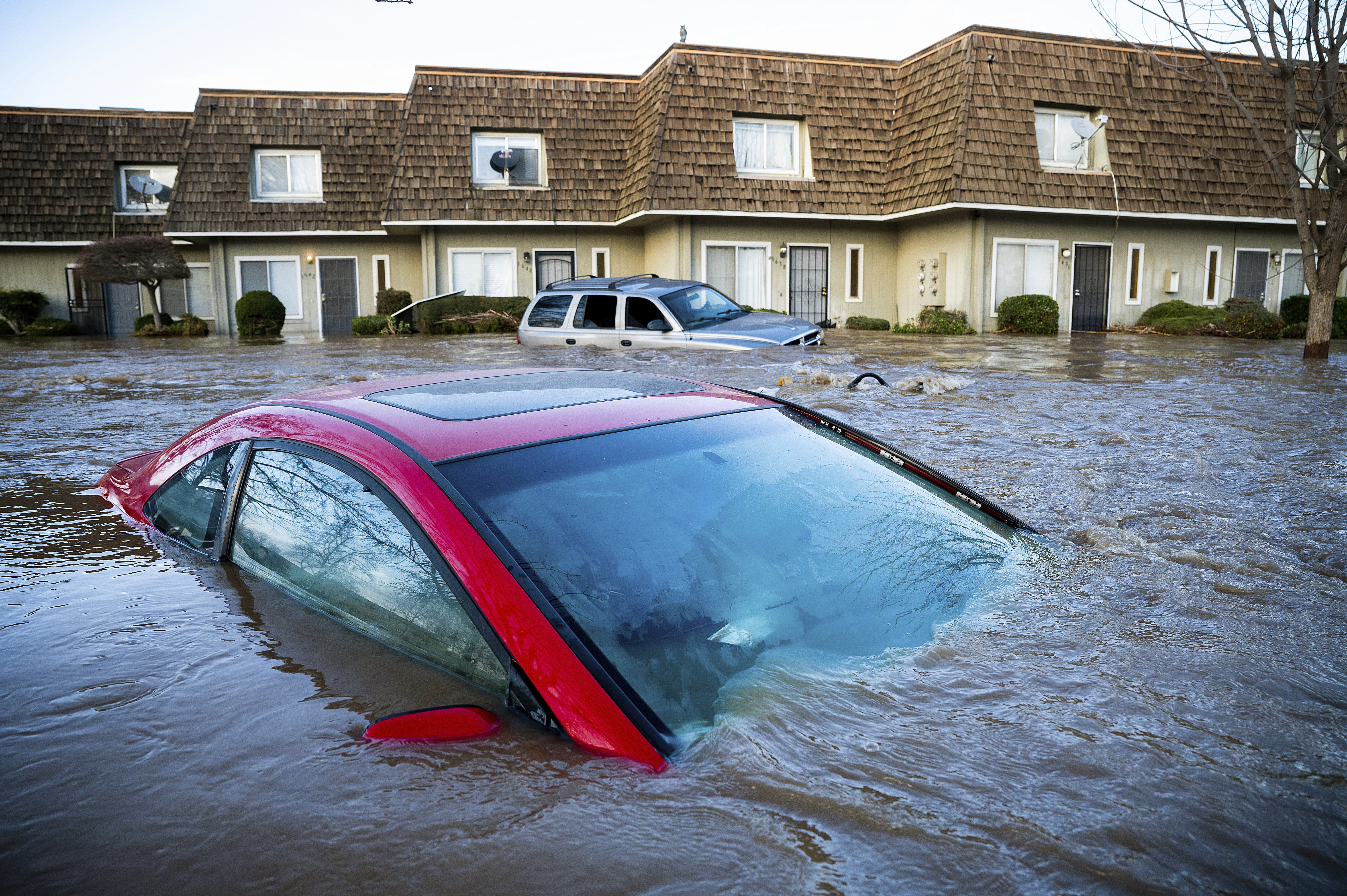 Floodwaters course through a neighborhood in Merced, Calif., on Tuesday, Jan. 10, 2023.