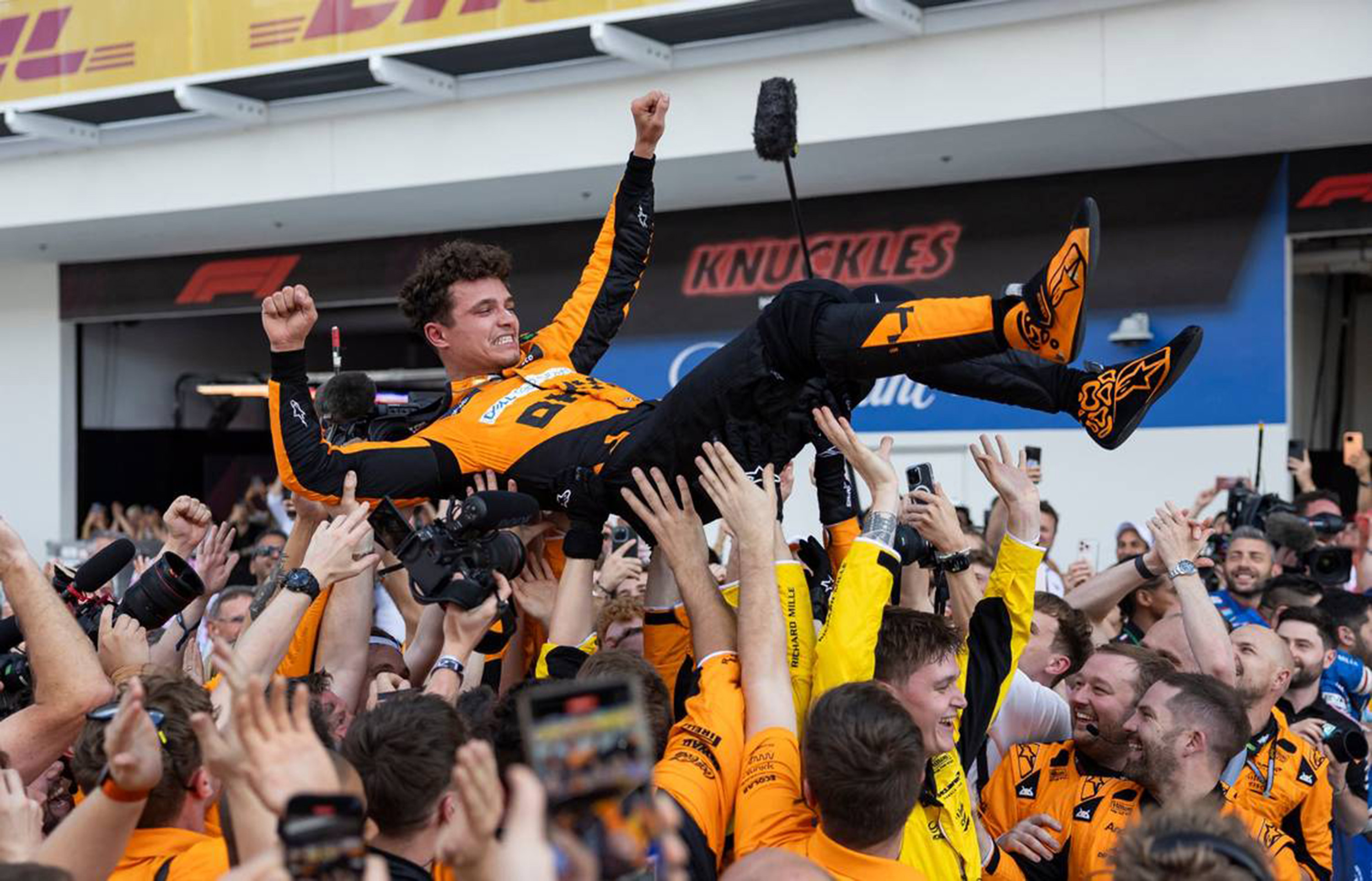 McLaren driver Lando Norris of Britain celebrates with crew members after winning the Formula One Miami Grand Prix at the Miami International Autodrome on Sunday, May 5, 2024, in Miami Gardens, Fla.