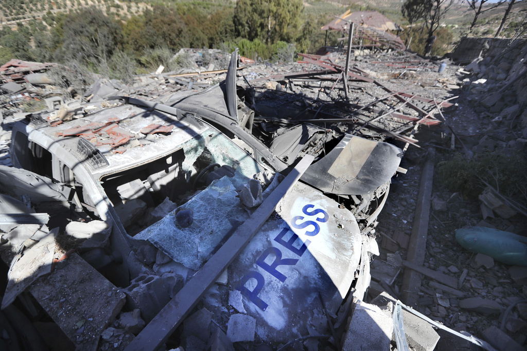 Destroyed vehicles used by journalists at the site where an Israeli airstrike hit a compound housing journalists, killing three media staffers from two different news agencies according to Lebanon's state-run National News Agency, in Hasbaya village, southeast Lebanon, Friday, Oct. 25, 2024. (AP Photo/Mohammed Zaatari)