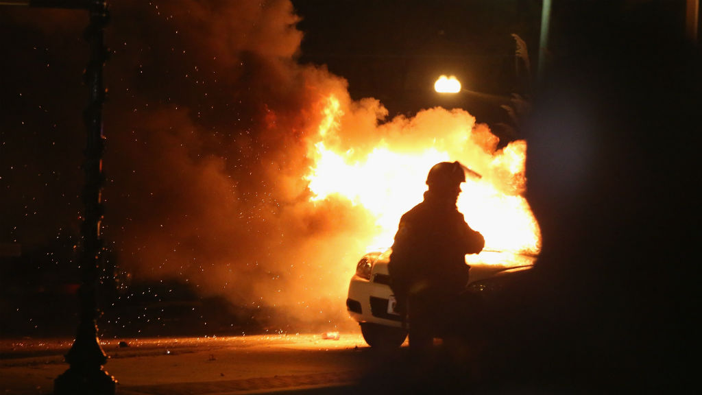 A squad car burns after protestors rioted following the grand jury announcement in the Michael Brown case. (Getty Images)