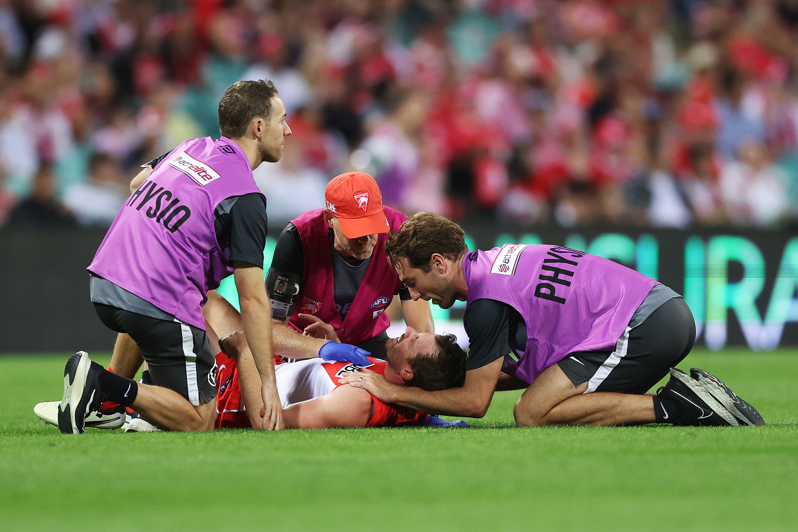 Harry Cunningham is attended to by medical staff after colliding with Peter Wright.