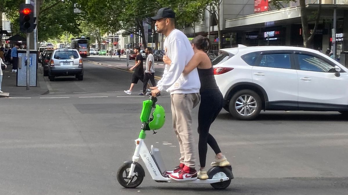 Nick Kyrgios has been photographed riding a scooter through the centre of Melbourne without a helmet.