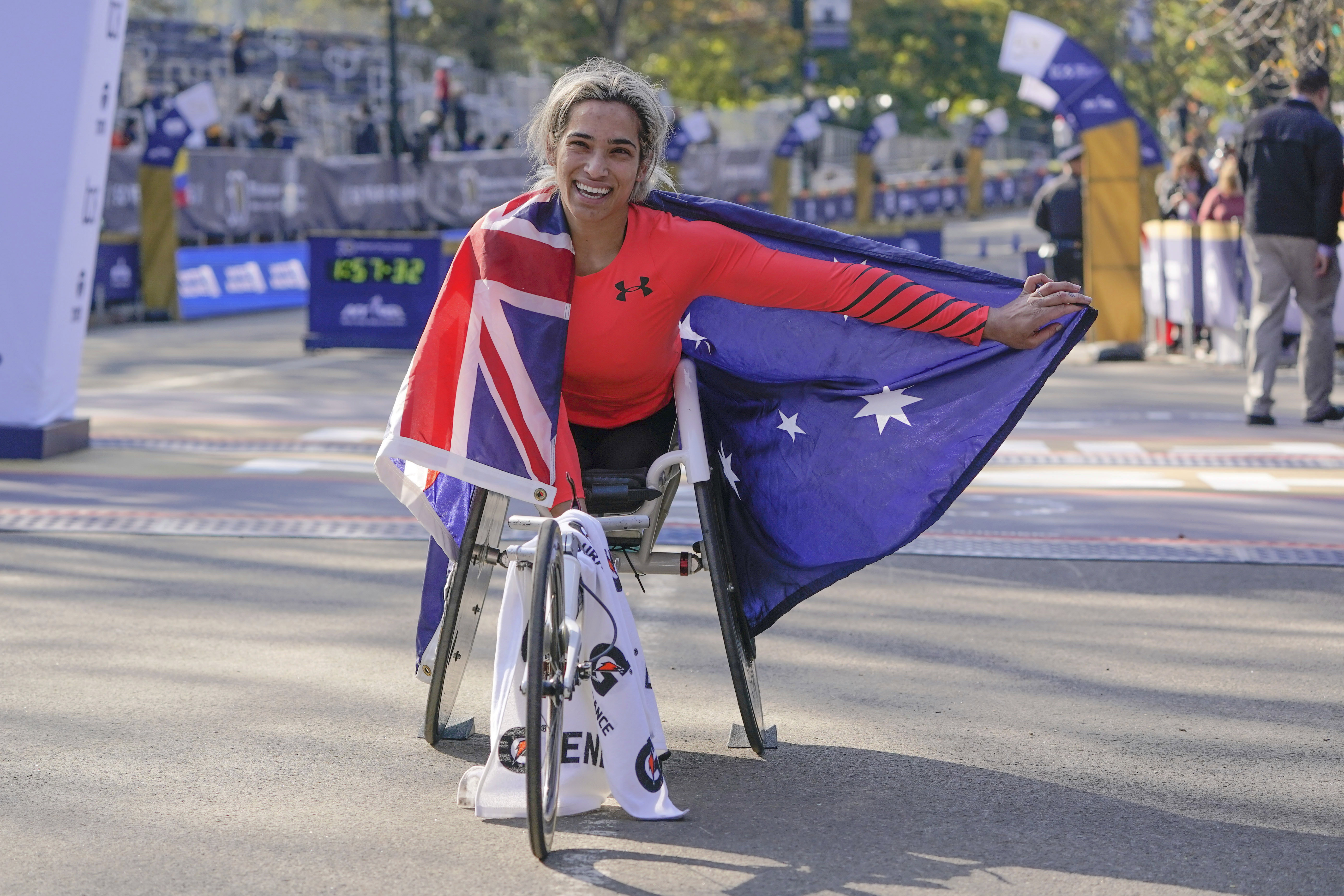 Madison de Rozario of Australia poses for a picture after crossing the finish line first in the womens wheelchair division of the New York City Marathon.
