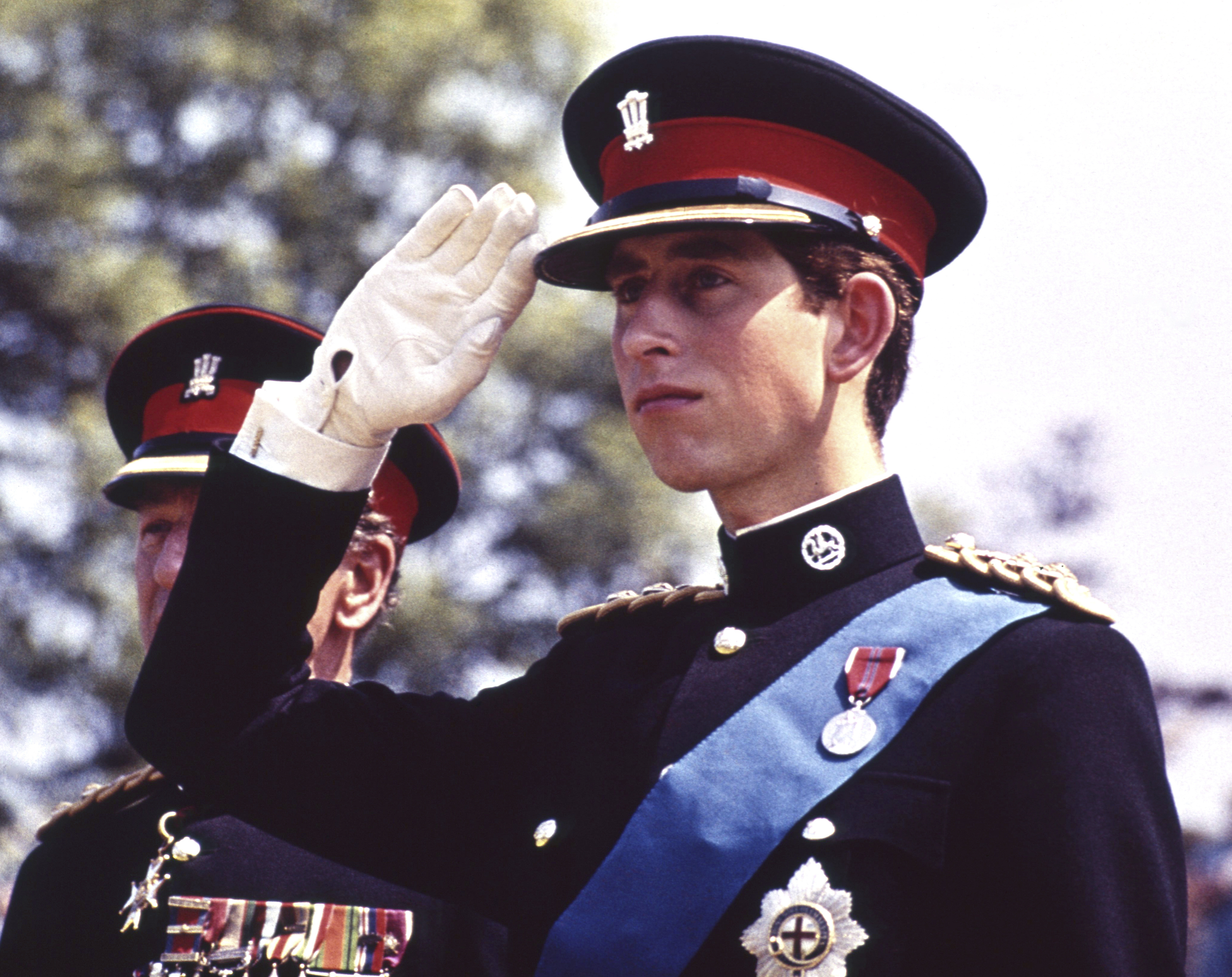 FILE - In this June 11, 1969 file photo, Britain's Prince Charles, dressed in the uniform of the Colonel in Chief of the Royal Regiment of Wales, salutes at the Regiment's Colour presentation, at Cardiff Castle in Wales. It was the first occasion for the Prince to wear uniform. Prince Charles has been preparing for the crown his entire life. Now, that moment has finally arrived. Charles, the oldest person to ever assume the British throne, became king on Thursday Sept. 8, 2022, following the de