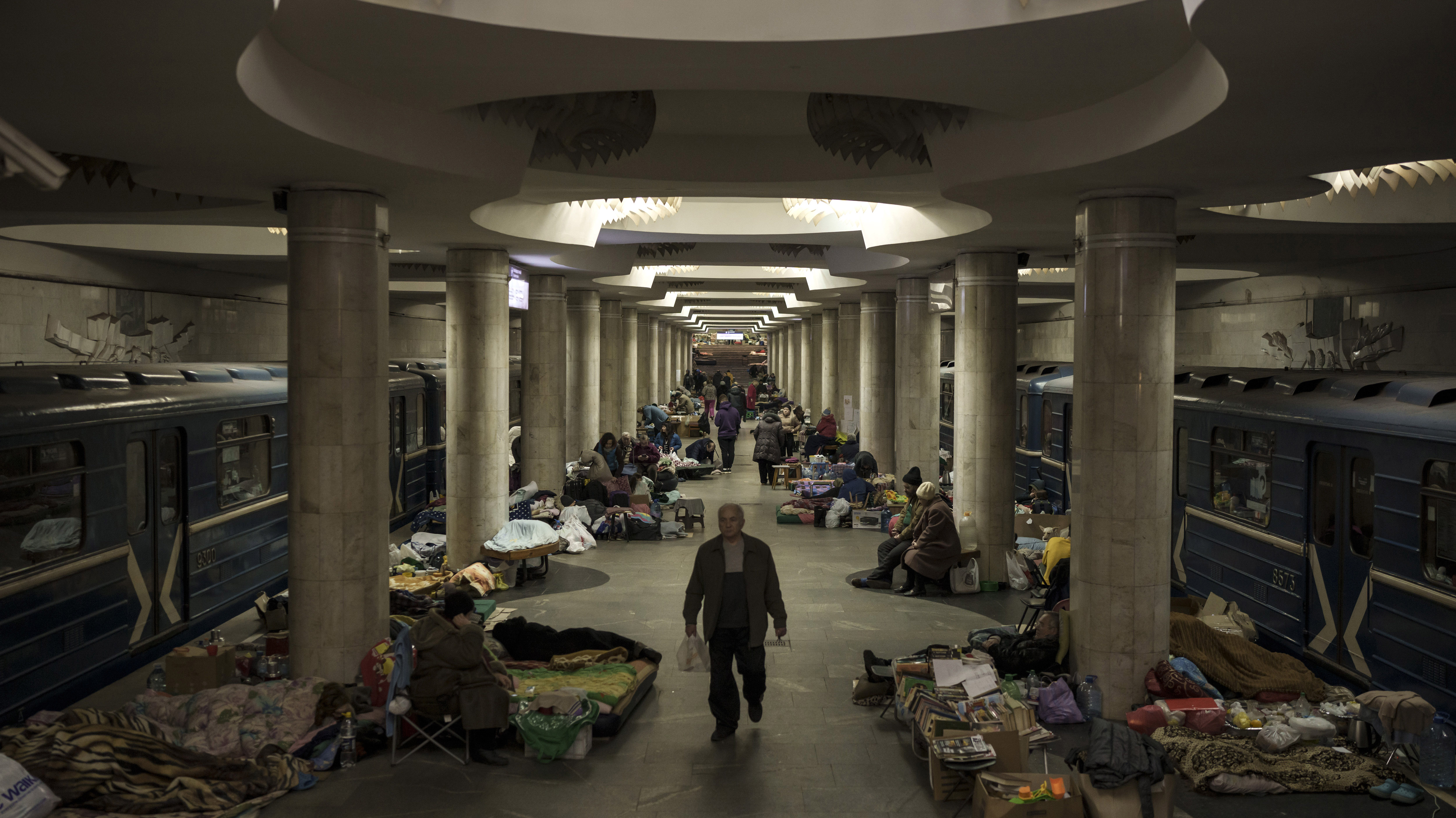 People stay in a metro station being used as a bomb shelter in Kharkiv, Ukraine.