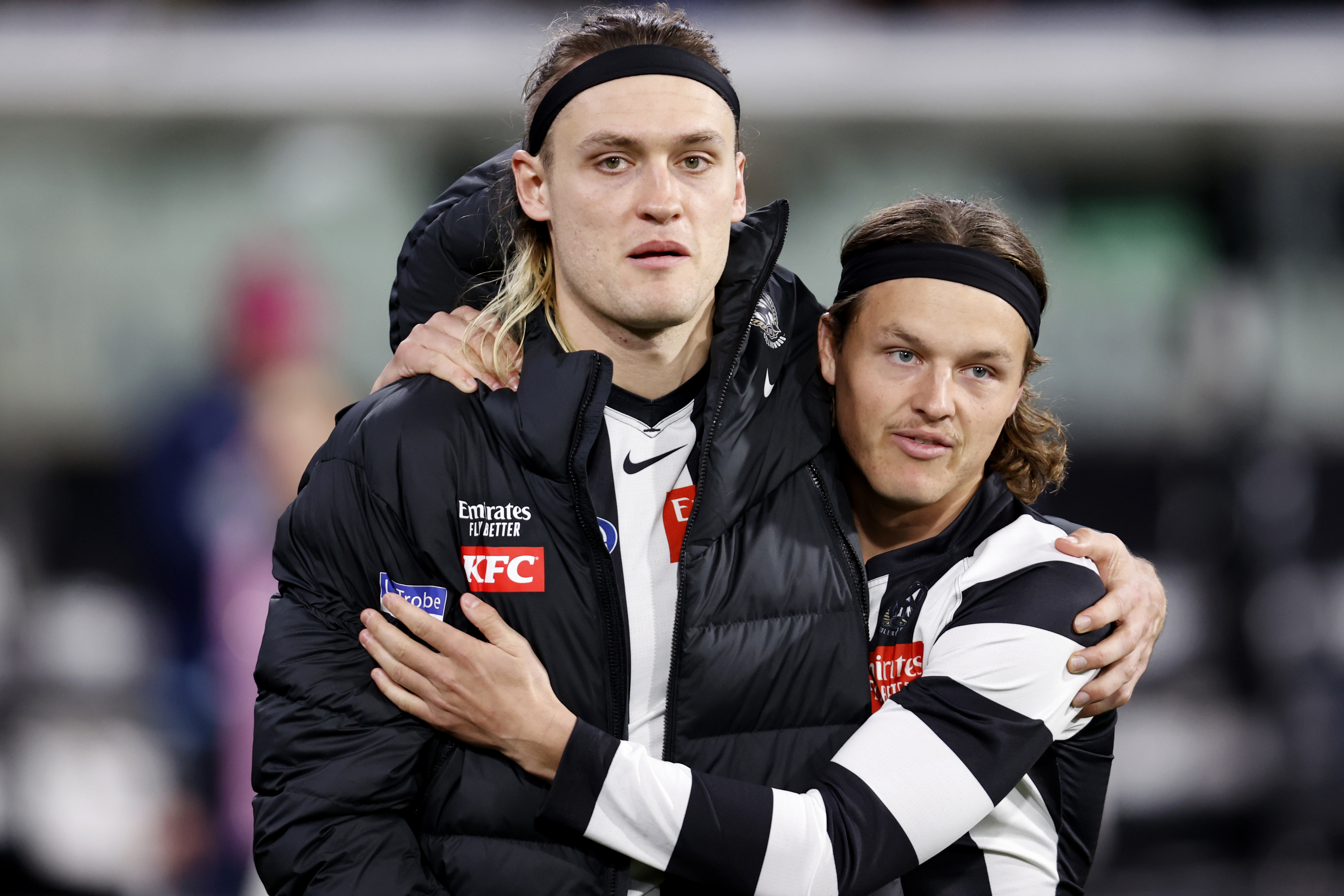 Darcy Moore and Jack Ginnivan embrace after a hamstring injury to the Pies captain.