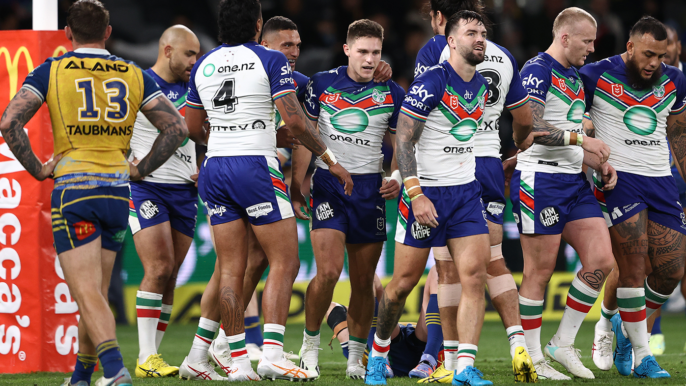 Luke Metcalf of the Warriors celebrates with team mates after scoring a try.
