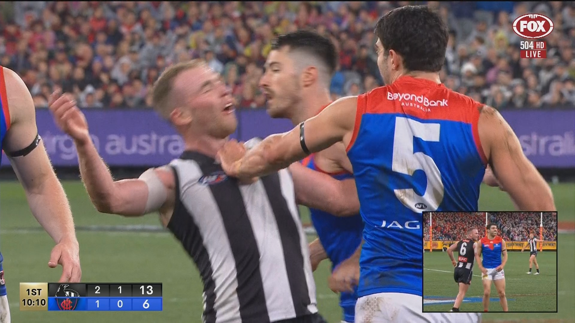Collingwood's Tom Mitchell flopped to the turf after a soft shove from Christian Petracca.