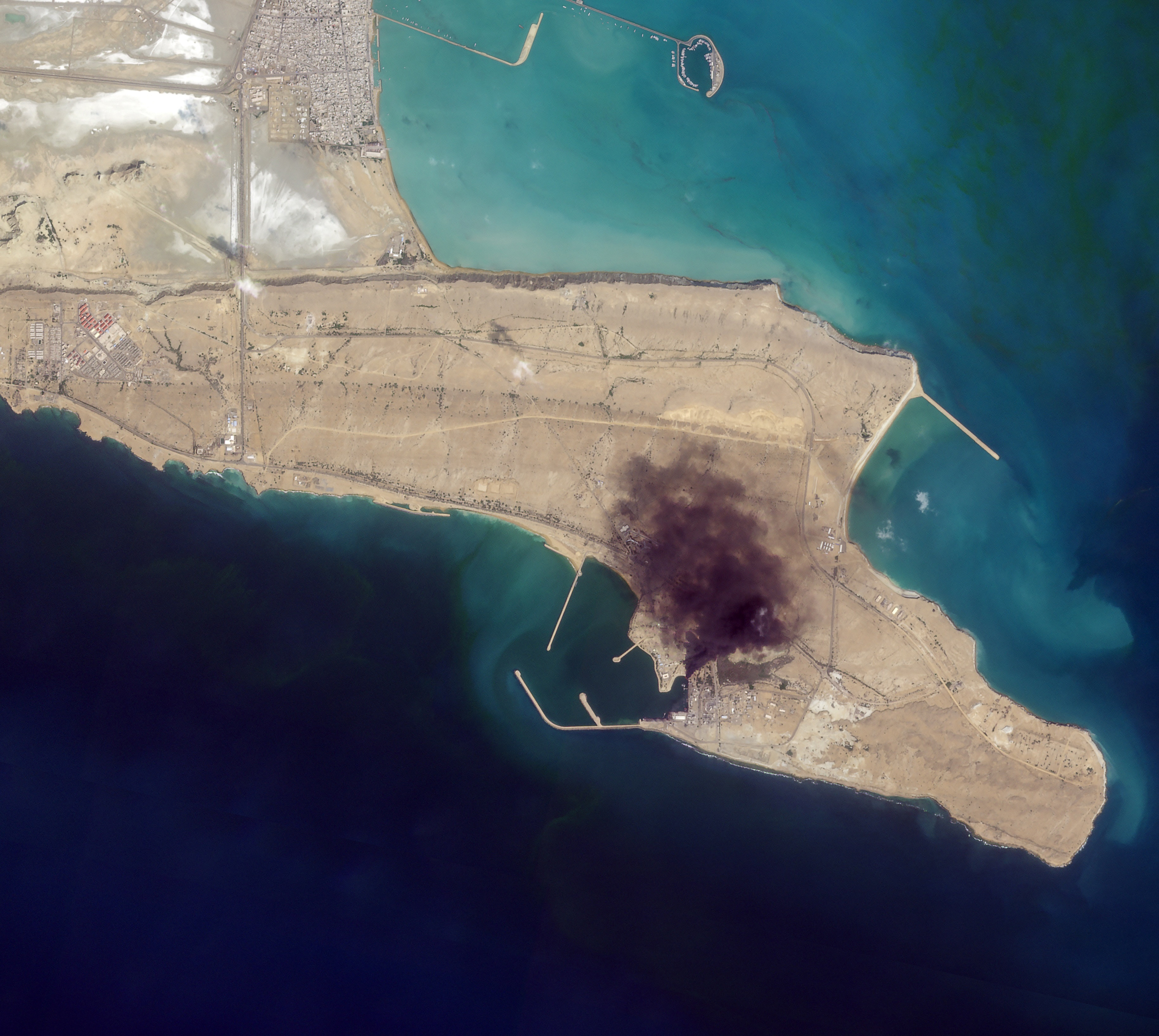 In this satellite photo from Planet Labs PBC, smoke rises over Konarak Naval Basin, Iran, March 1, 2026.  