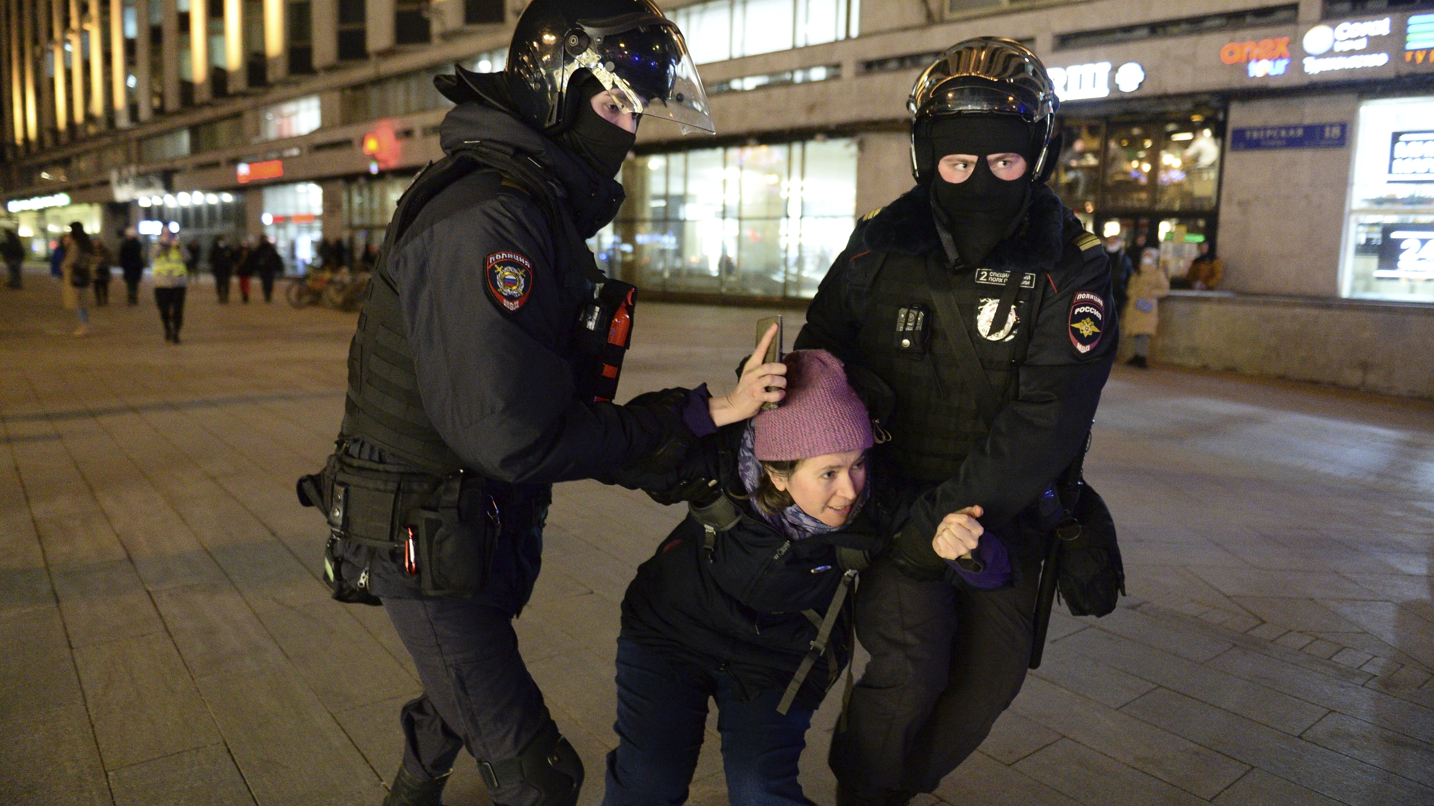 Police officers detain a woman in Moscow, Russia.