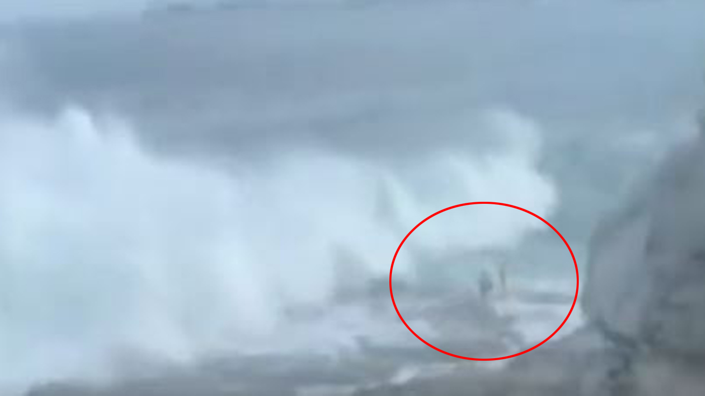 The moment the wave struck the couple was caught on video by a witness.