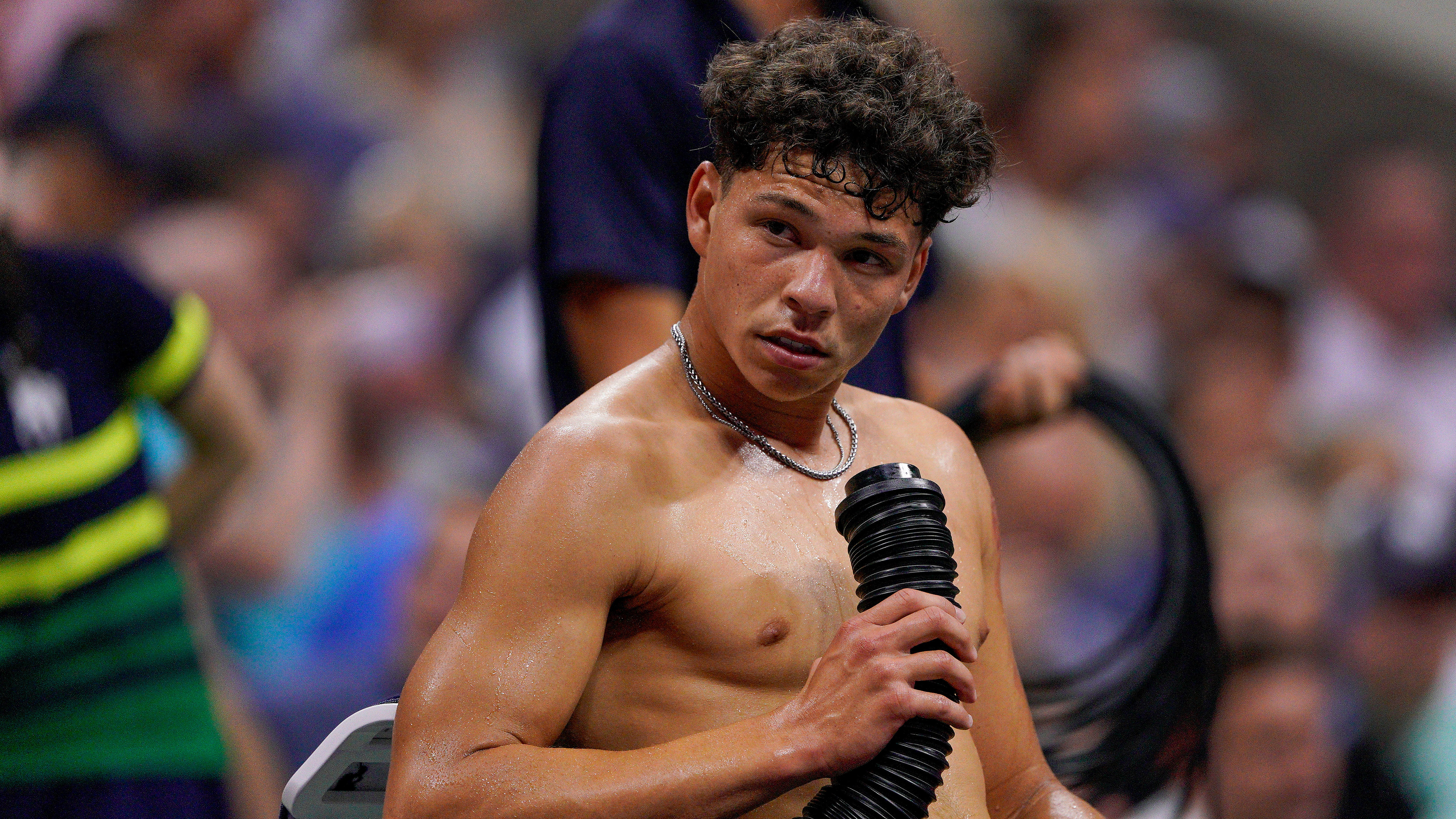 America's Ben Shelton blows cold air on his body during a break between games against Frances Tiafoe during their quarter final at the US Open. 