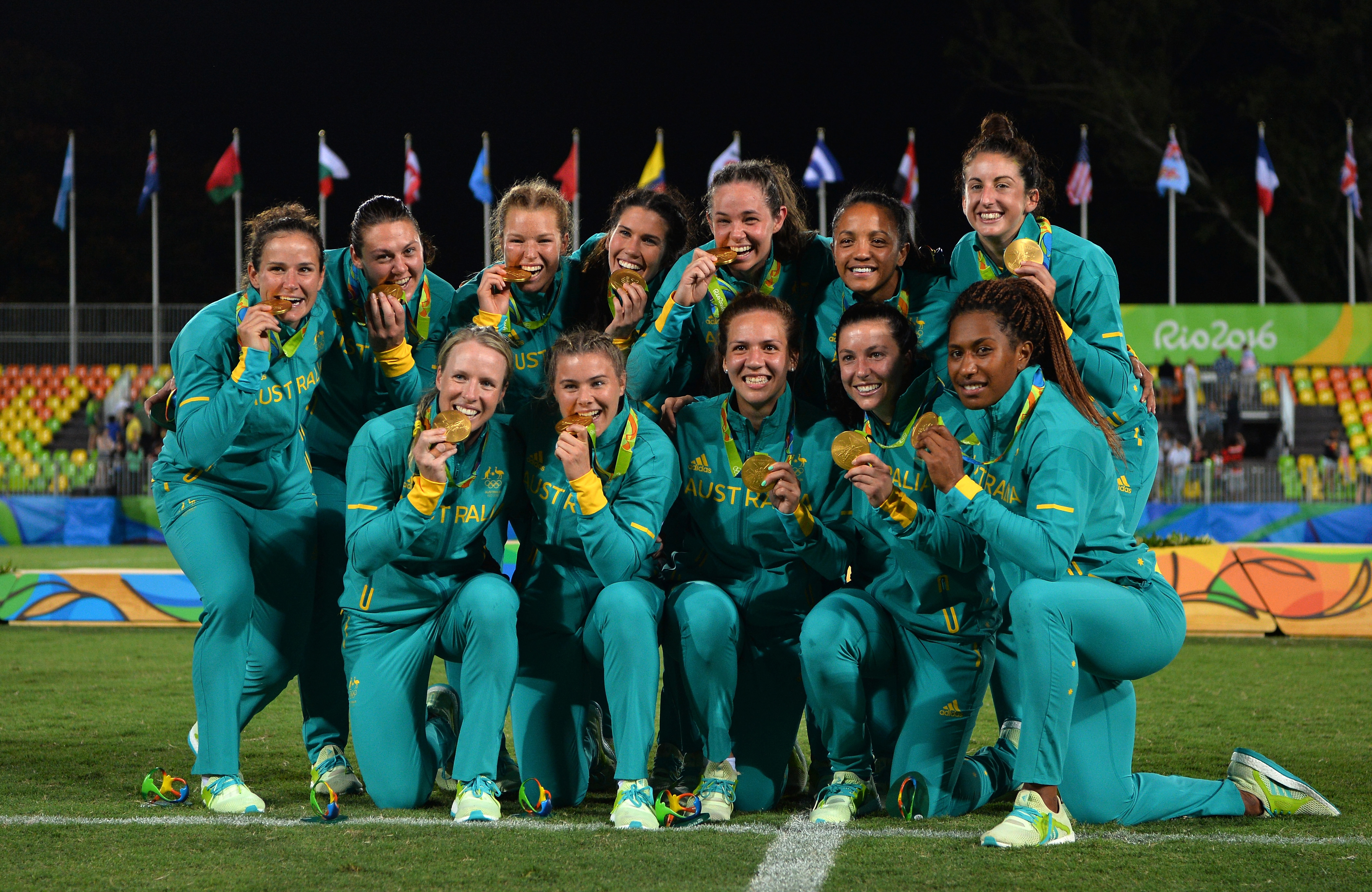 Australia pose with their gold medals following victory during the women's rugby sevens gold medal match at the the Rio 2016 Olympic Games.