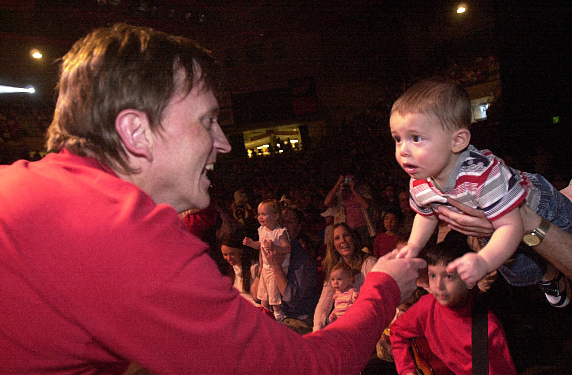 March 29, 2004 / Denver / Wiggles' member Murry Cook, left, reaches for Ben Ives 11 months from Thornton CO. The Wiggles, a kids group came to Denver for 4 concerts at Denver University March 29, 2004. (Sammy Dallal / Daily Camera)