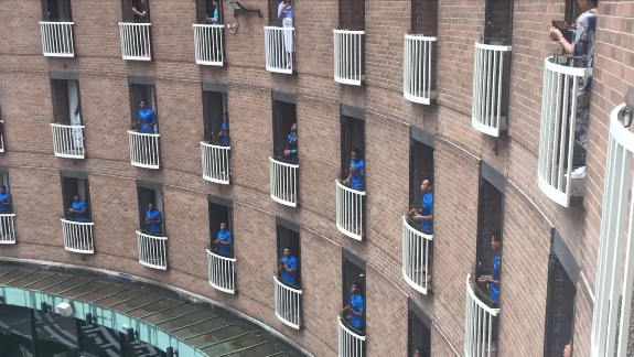 Fijian rugby players' rousing song on their balconies.