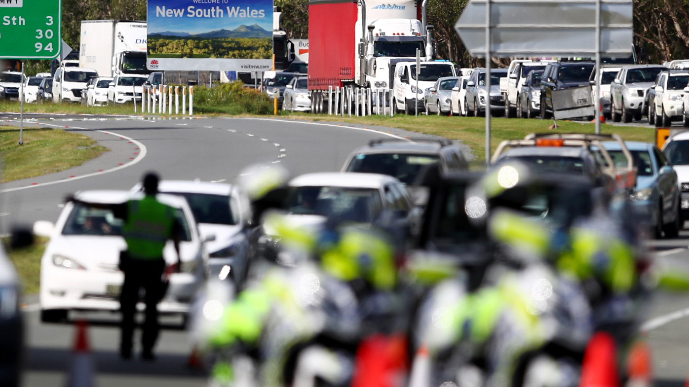 Queensland Police stop vehicles at a checkpoint at the Queensland-New South Wales border in Coolangatta.