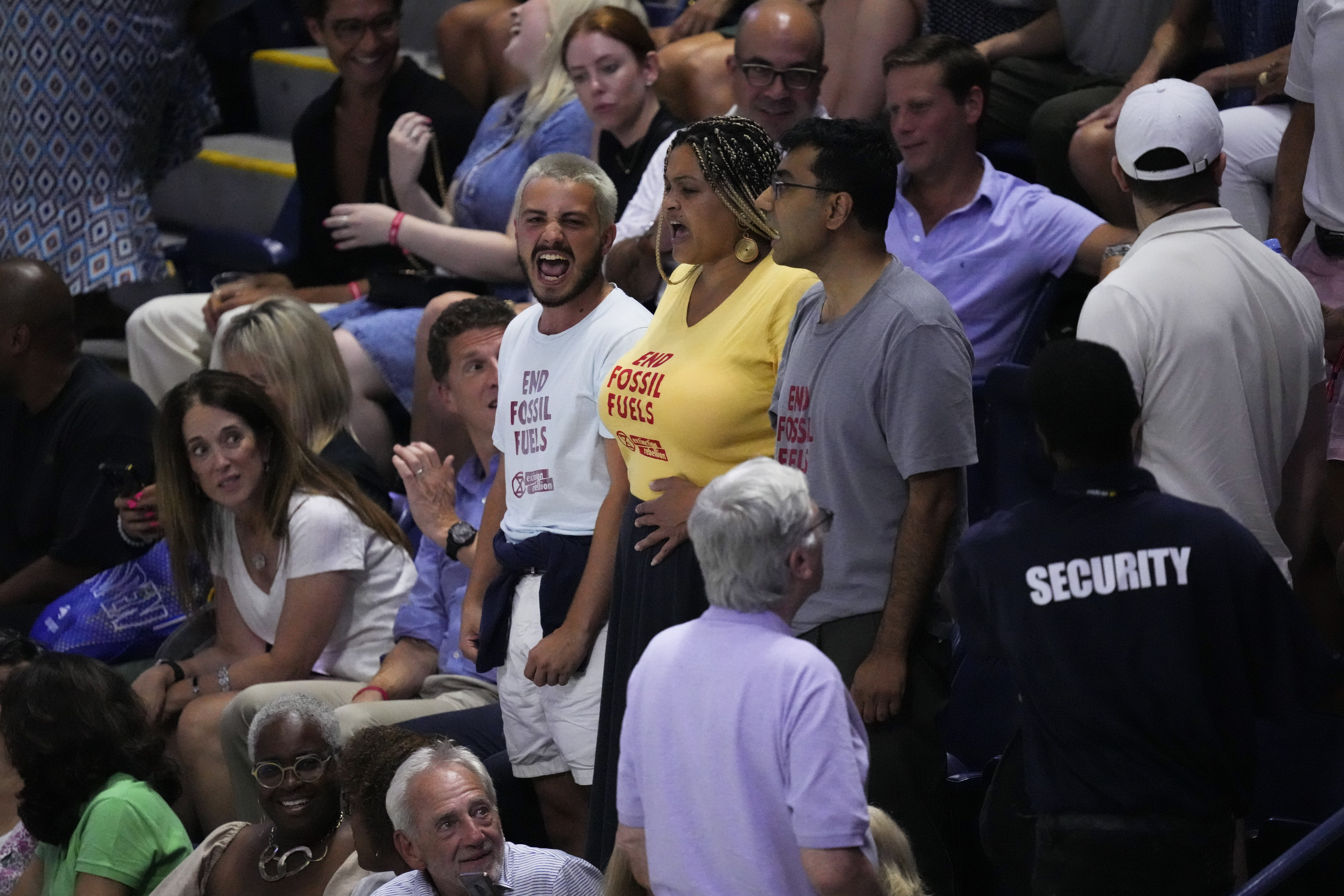 Protesters demonstrate at a match between Coco Gauff and Karolina Muchova.