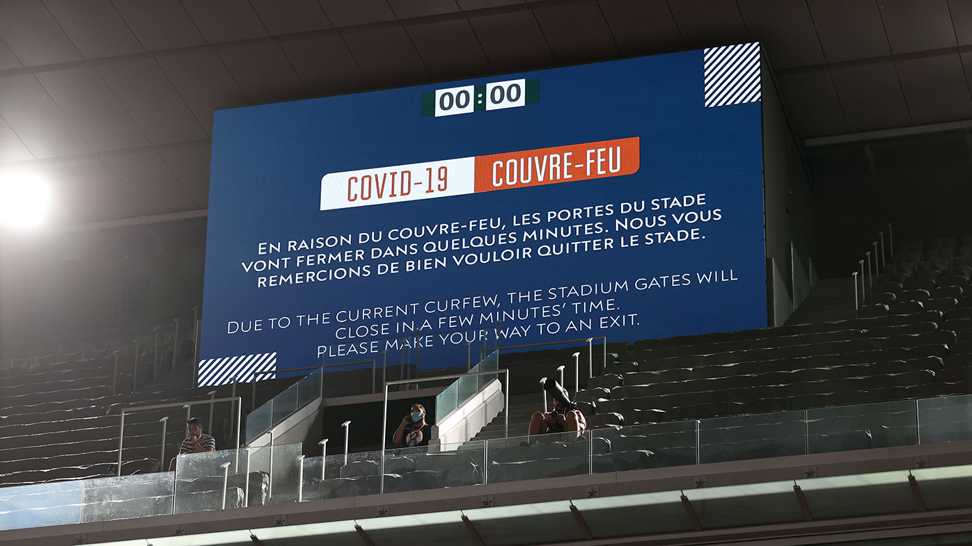 A board is displayed as play is suspended with fans being made to leave the stadium due to government curfew restrictions during the Mens Singles Quarter-Final match between Novak Djokovic of Serbia and Matteo Berrettini of Italy at Roland-Garros.