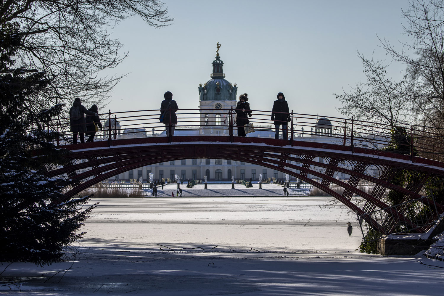 People walk in the gardens of Charlottenburg Palace covered in snow on February 12, 20211 in Berlin, Germany