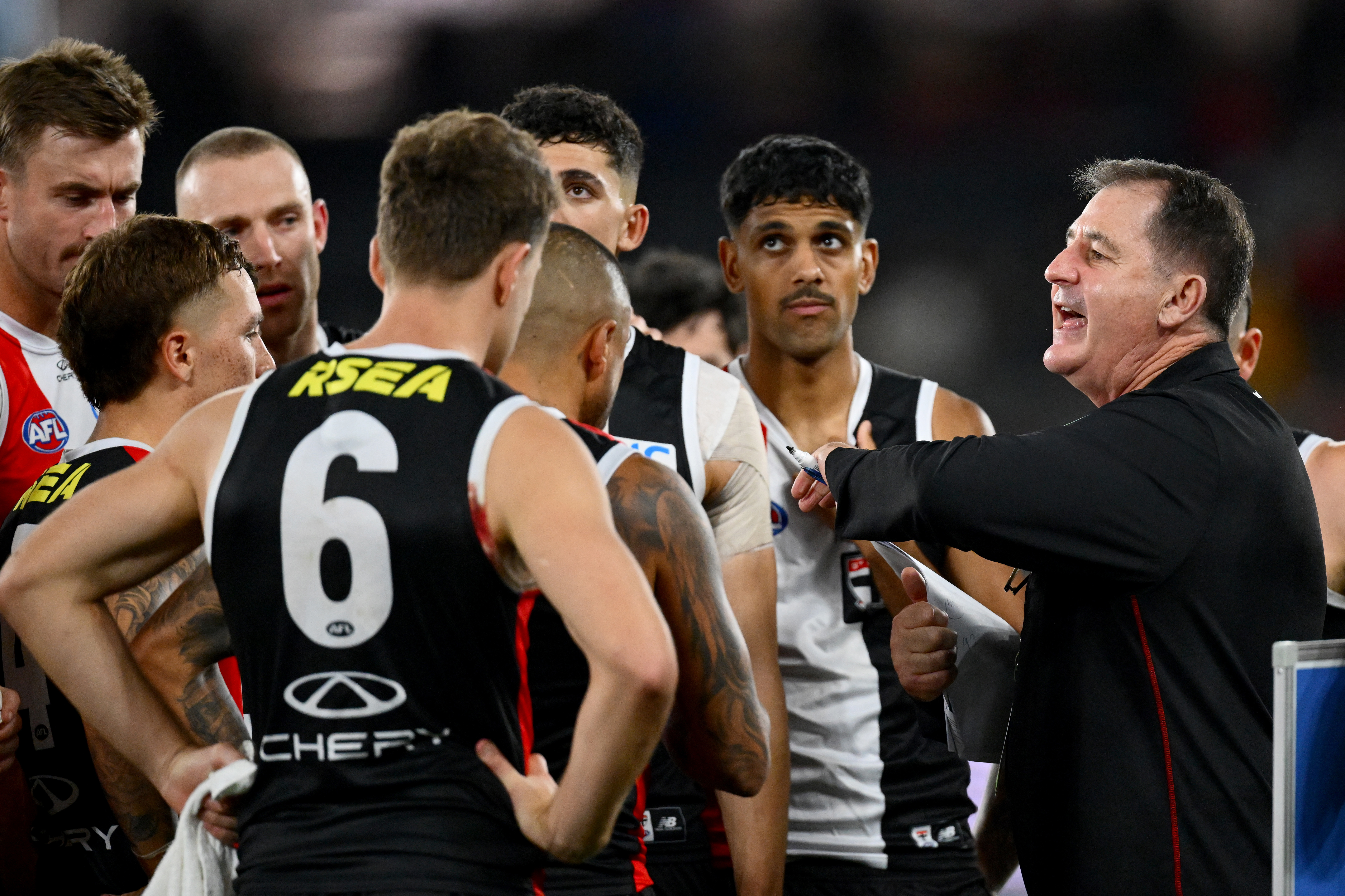 MELBOURNE, AUSTRALIA - MAY 02: Ross Lyon, Senior Coach of the Saints speaks to his players during the round eight AFL match between St Kilda Saints and Fremantle Dockers at Marvel Stadium, on May 02, 2025, in Melbourne, Australia. (Photo by Quinn Rooney/Getty Images)