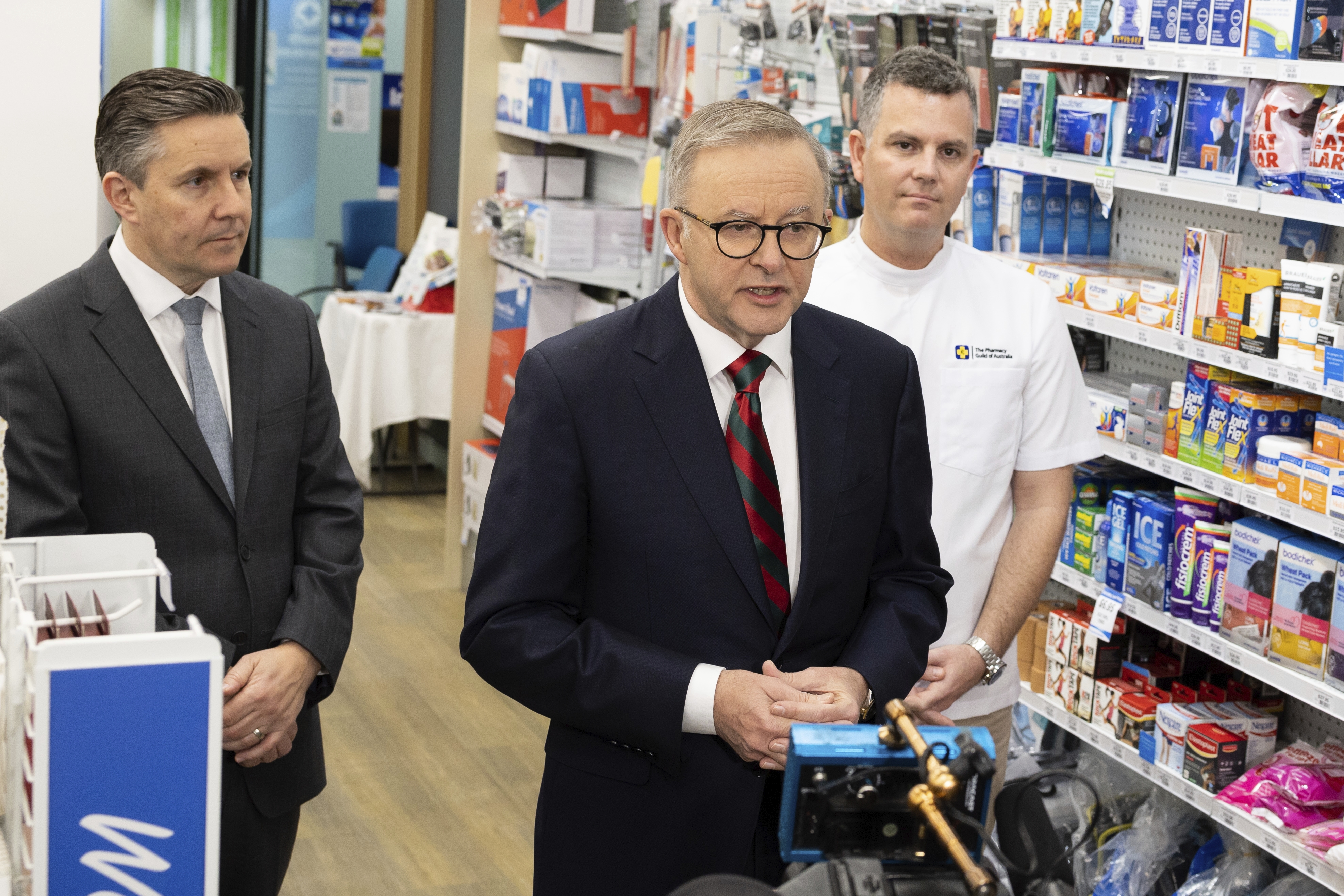 Minister for Health and Aged Care Mark Butler, Prime Minister Anthony Albanese and Trent Twomey, National President, Pharmacy Guild of Australia, at a doorstop interview during a visit to Capital Chemist in Kingston, ACT, on Wednesday 7 September 2022. fedpol Photo: Alex Ellinghausen