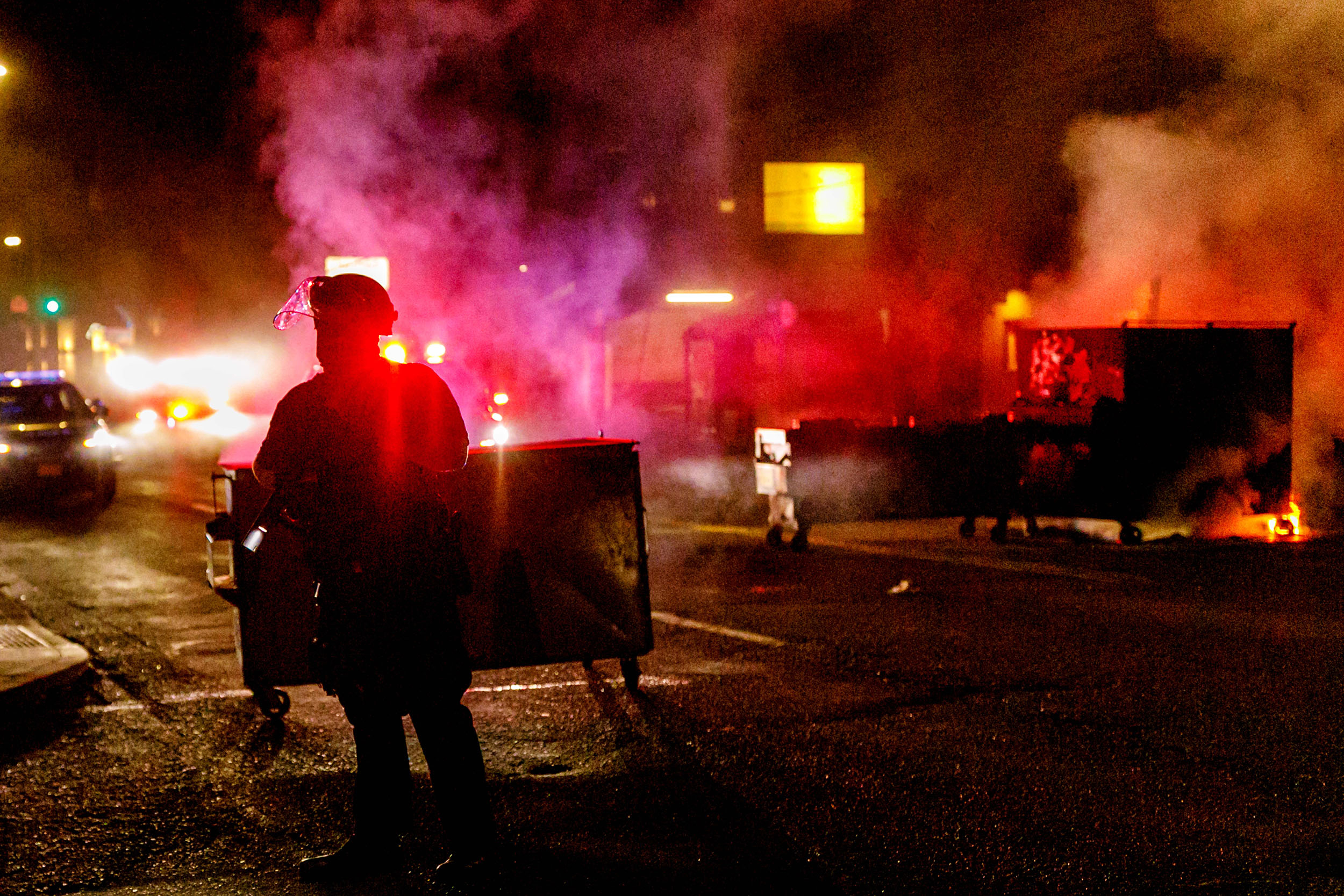 People protesting police brutality spray graffiti and start fires at the Portland Police Union building on Friday.