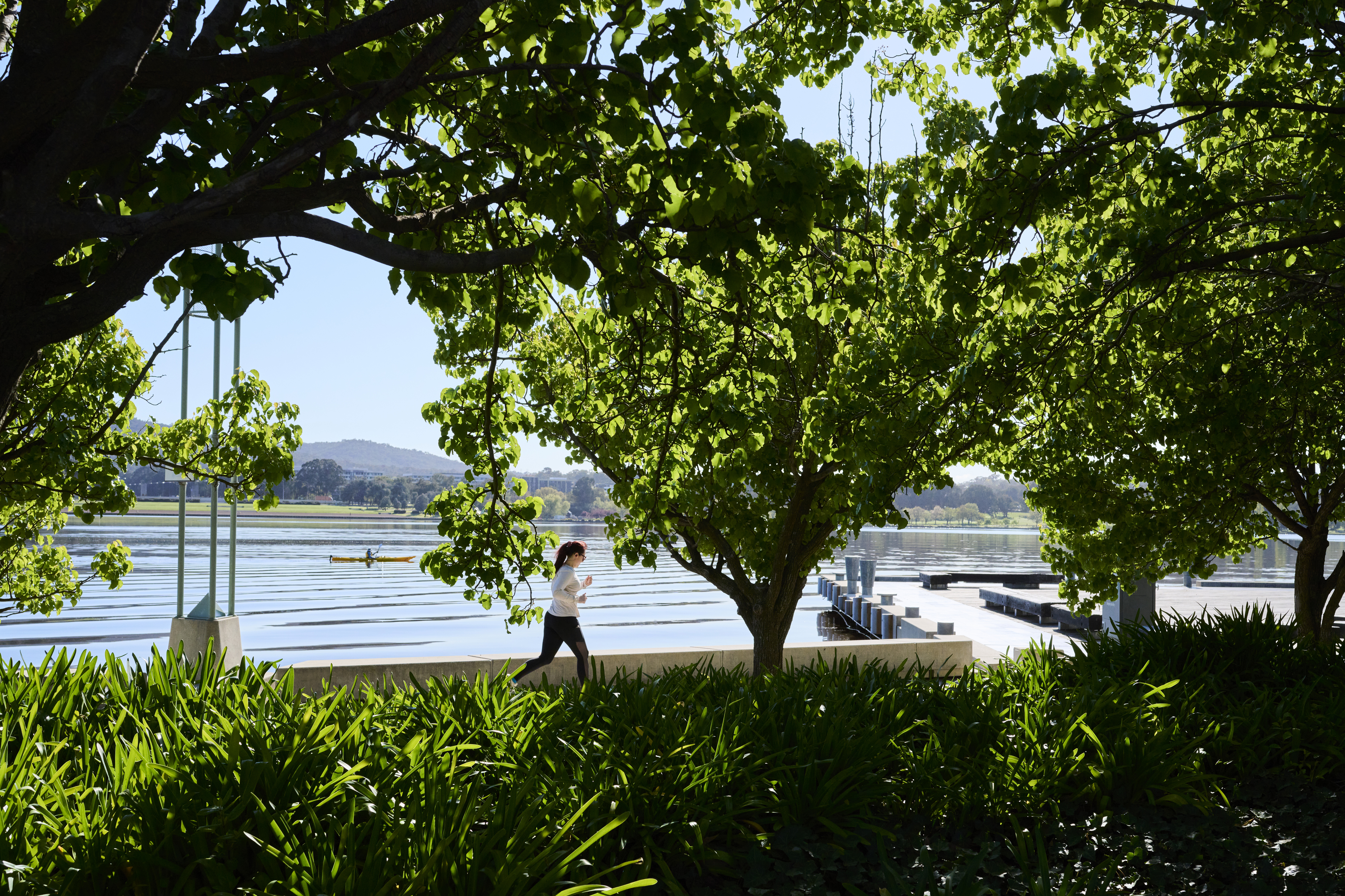 CANBERRA, AUSTRALIA - OCTOBER 08: Exercisers by Lake Burley Griffin on October 08, 2021 in Canberra, Australia. Lockdown restrictions remain in place for Canberra, with residents subject to stay-at-home orders as the ACT continues to record new local COVID-19 cases. The current lockdown restrictions are due to remain in place until Friday 15 October 2021. (Photo by Rohan Thomson/Getty Images)